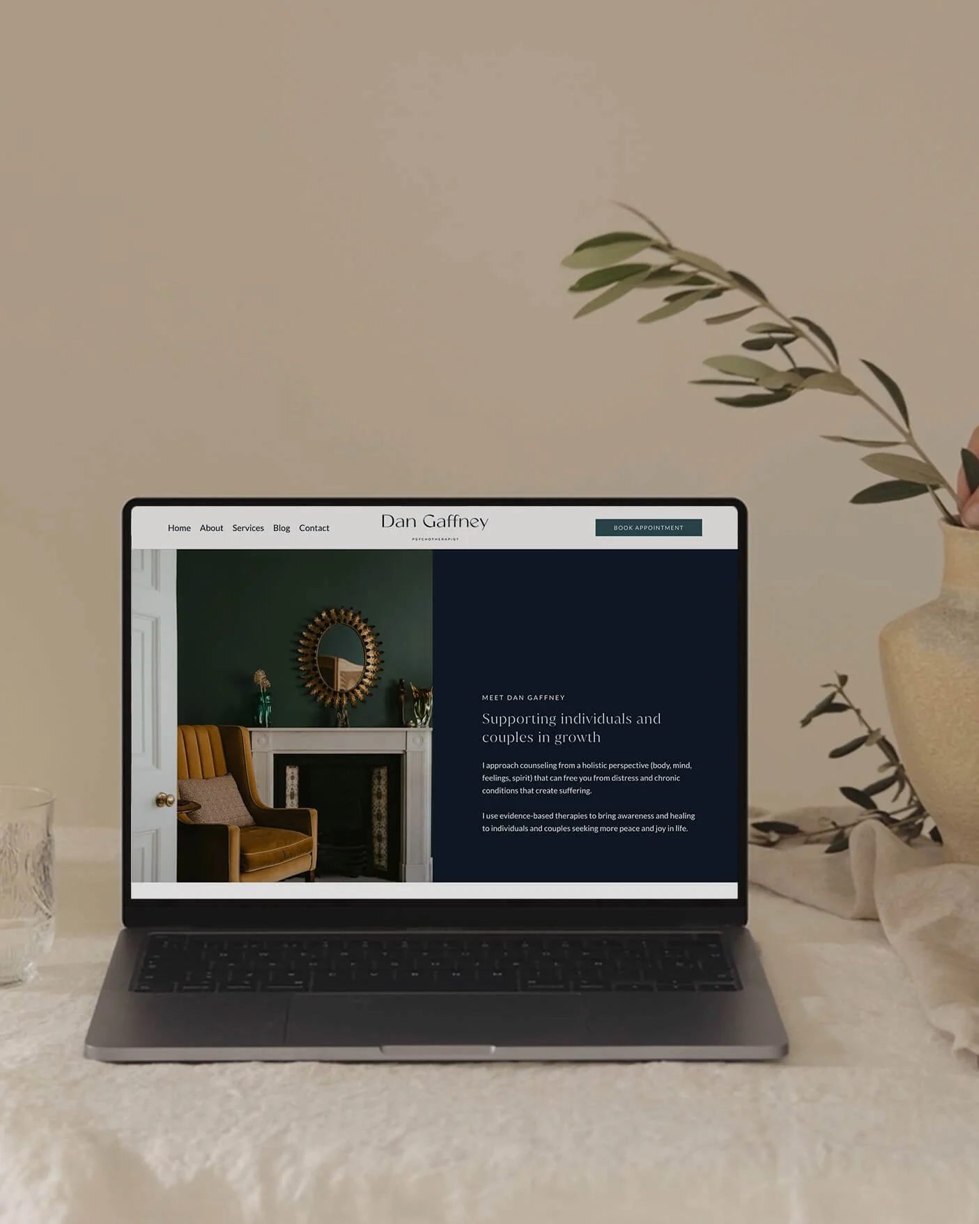 Squarespace website design for a psychotherapist – laptop mockup showing the about page of Dan Gaffney Psychotherapist, featuring a deep navy and bottle green colour palette with serif typography.