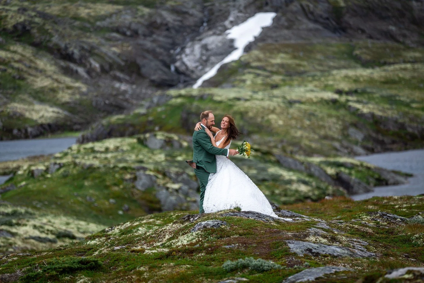 Some couples want a church. Some want a ballroom. These two wanted a moss-covered hillside with snow-capped mountains behind them and yellow wildflowers in her hands.

We think they made the right call.

When you get married in Norway, the landscape 