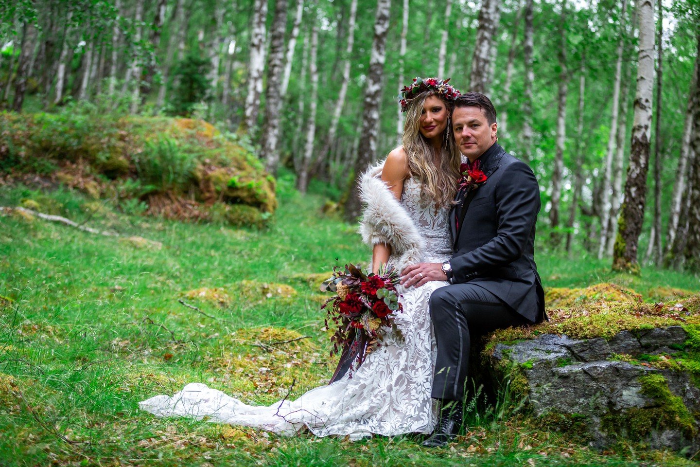 Callie &amp; Brad chose the forest. And the forest chose them right back.

June 4th, deep in the Norwegian woodland. A floral crown woven with fire-red blooms. A kiss on the rocks with snow-capped fjords stretching behind them. Birch trees standing l