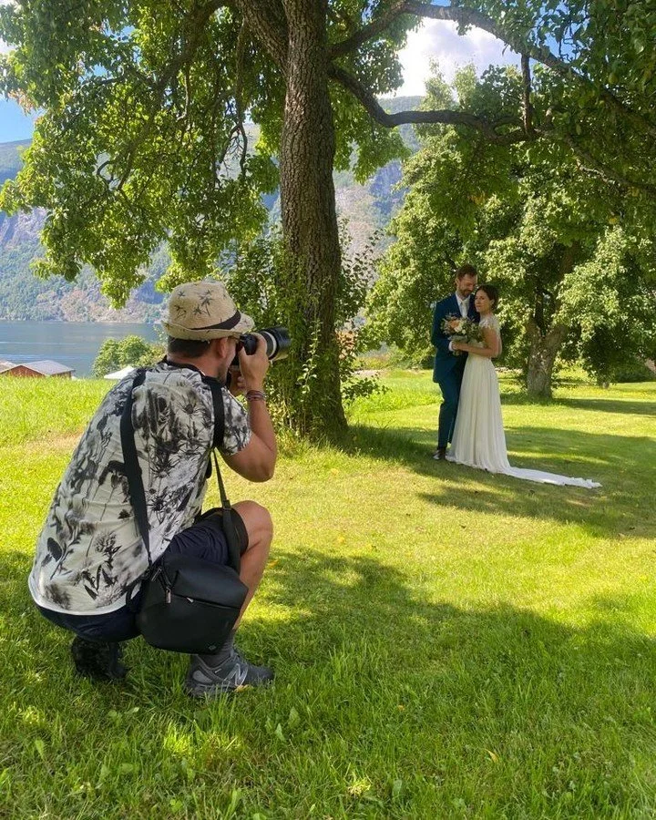 This is what 25 years behind a camera looks like.

Paul Edmundson, founder of Fjord Weddings &amp; Elopements, scouting the light, framing the moment, capturing something real.

[Unless Paul is on holiday with his babies] every wedding we create is p