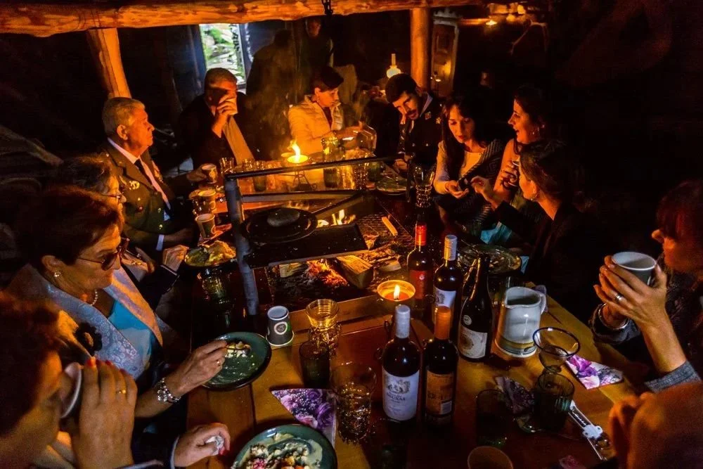 Proper fjord feasting around the open fire in a 500 year old barn.

When the ceremony is done and the sun starts to drop, the best part of a Norwegian wedding day begins. Long tables. Local ingredients. An open fire. And the people you love gathered 