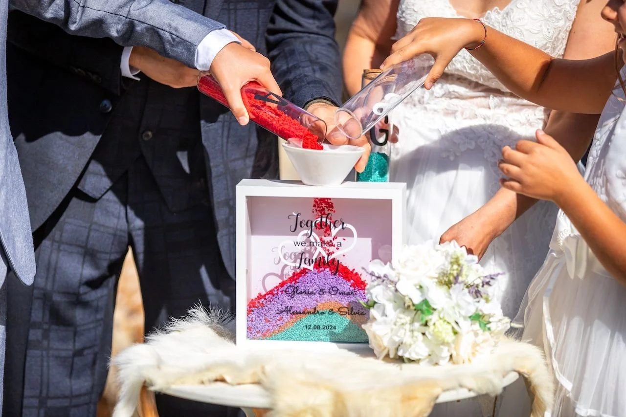 The sand mixing ritual. One of our favourite ceremonies to be part of.

Each person pours their own colour of sand into a shared vessel. The colours layer and blend, and what is created can never be unmixed. It is a beautiful, tangible symbol of two 
