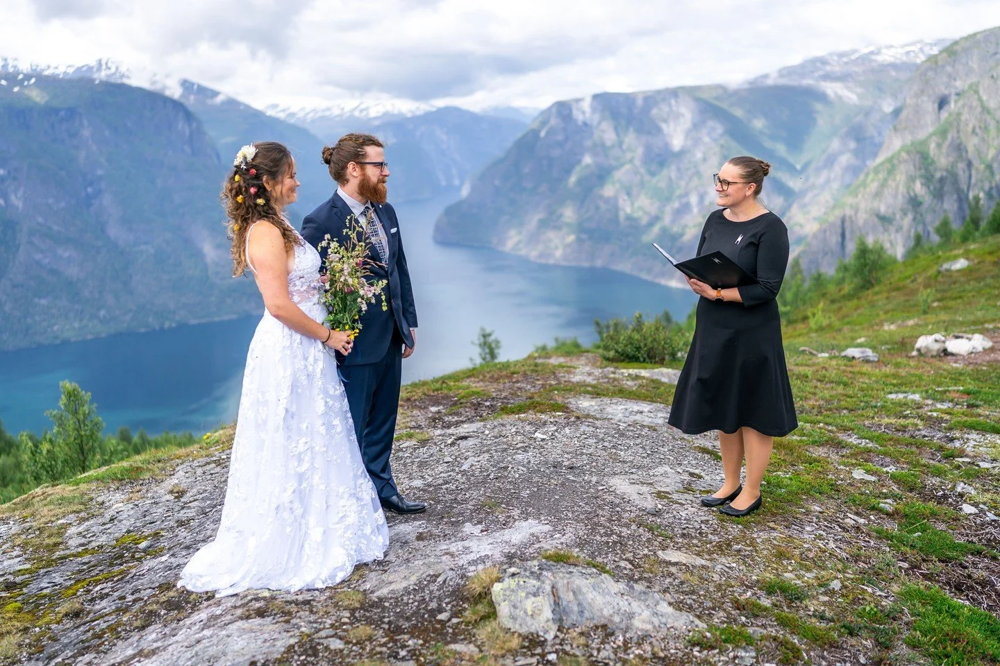 A ceremony on a fjord mountain. A cloudy sky. A fjord that goes on forever.

No sunshine needed.

One of the things we love most about shooting weddings in Norway is that the weather always gives you something. On a day like this, the cloud creates a