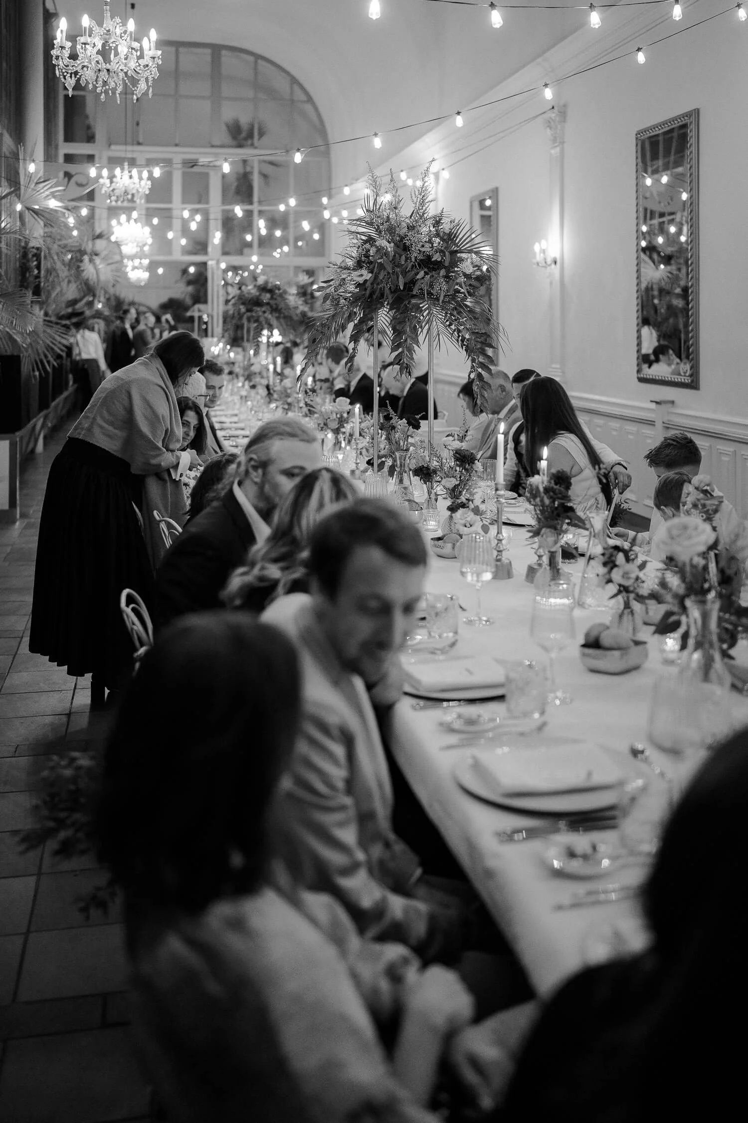 Gäste an einer Tafel bei einer Hochzeit im Schlosscafé Palmenhaus München