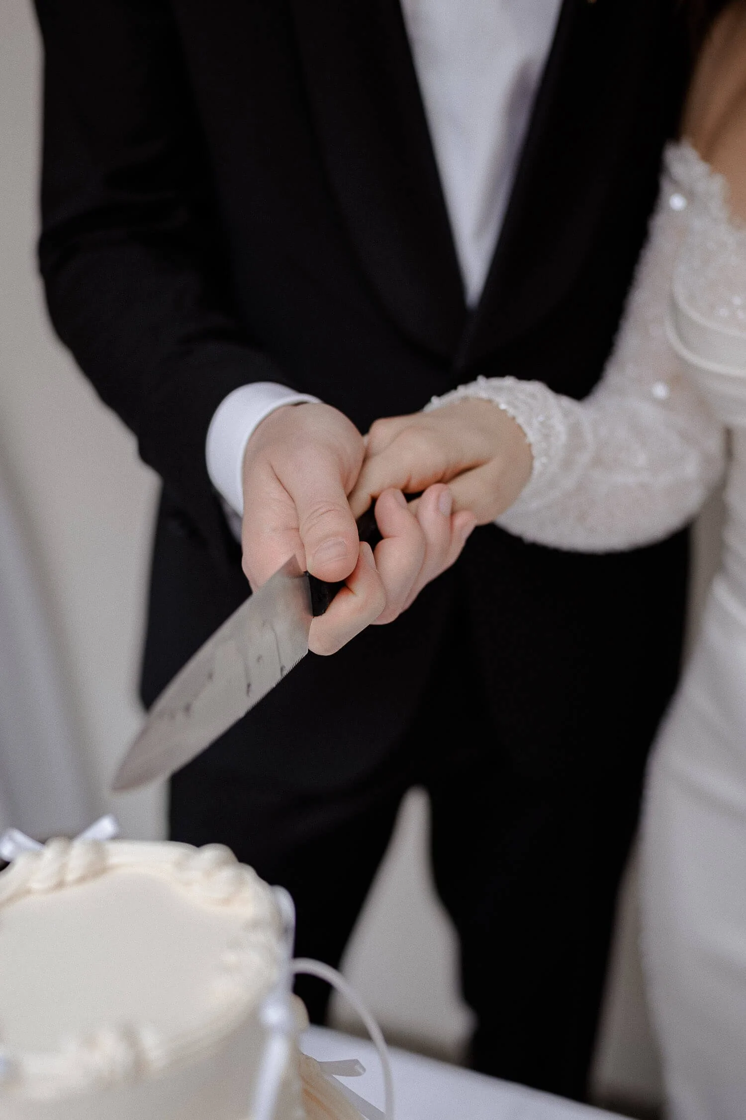 Brautpaar schneidet Hochzeitstorte im Schloss Hohenkammer gemeinsam an.