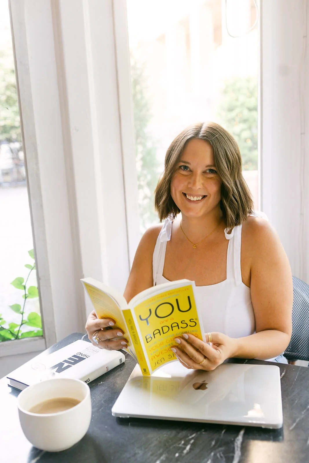 Polly Clover holding You Are a Badass Book