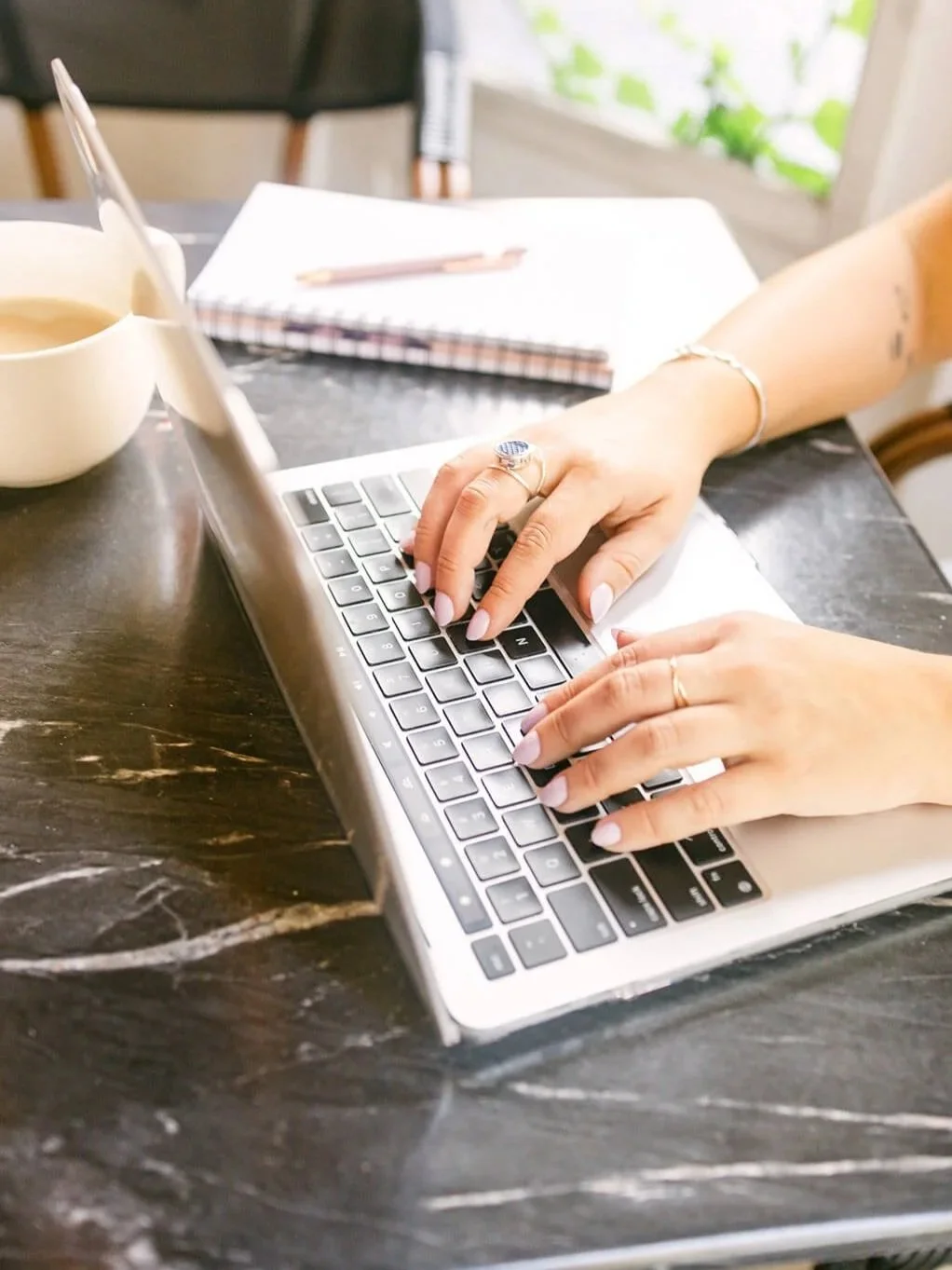 Polly Clover typing website copy on laptop