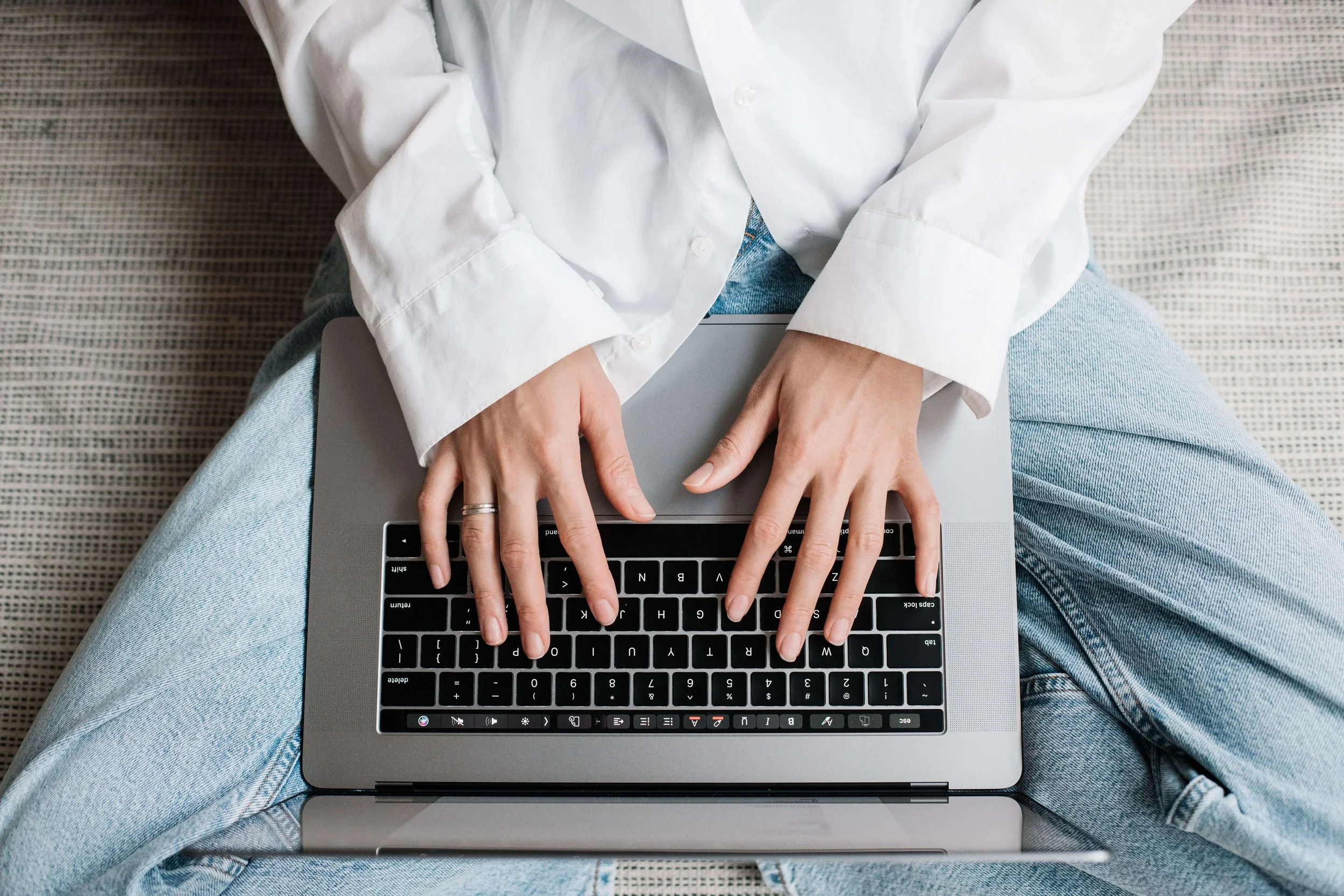 person typing on laptop to represent starting a blog