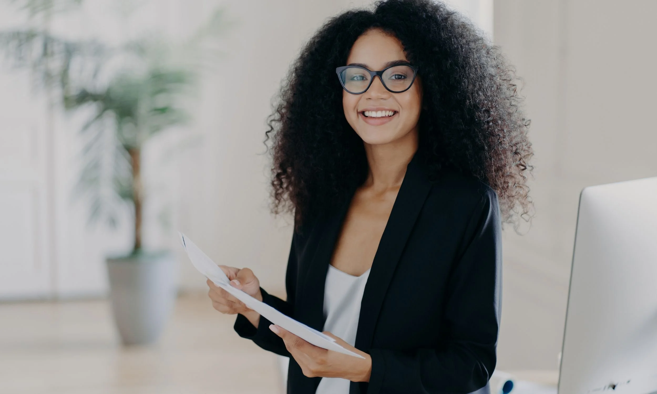 Virtual Executive Assistant at computer with papers