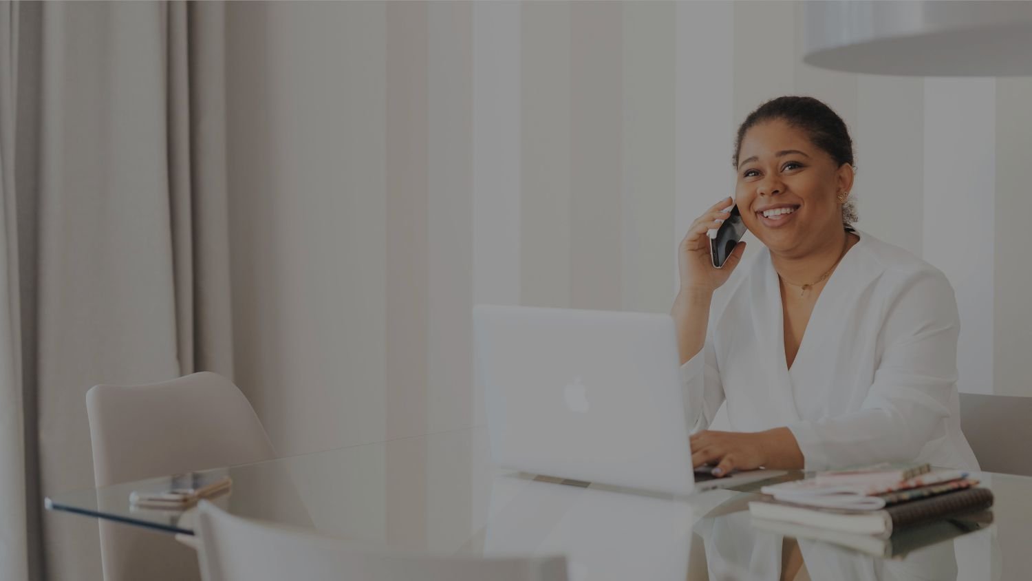 Fractional Executive Assistant with phone and laptop