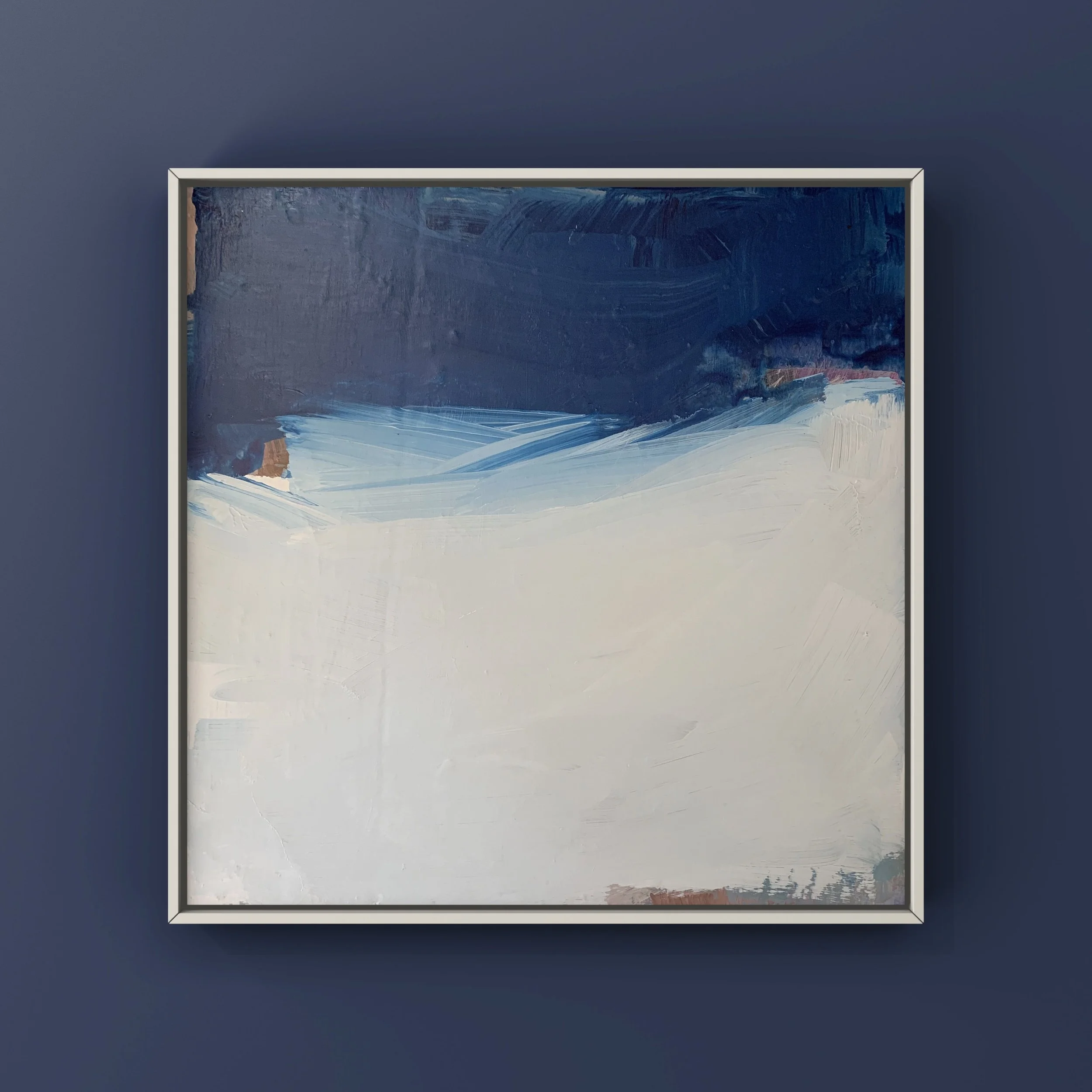 Abstract landscape painting with dark blue sky, light blue middle, and white foreground, framed and mounted on a dark blue wall.