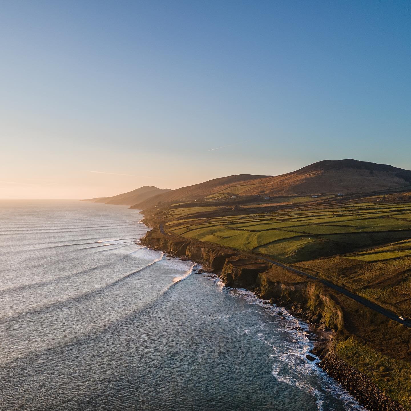 The coastal route along Inch on the Dingle Peninsula ☀️

Nice warm summer feel to the weather over the last week!

#inch #inchbeach #dinglepeninsula #dinglepeninsulatourism #cliffs #coastline #ocean #sunset #drone #mountains #road #wildatlanticway #k