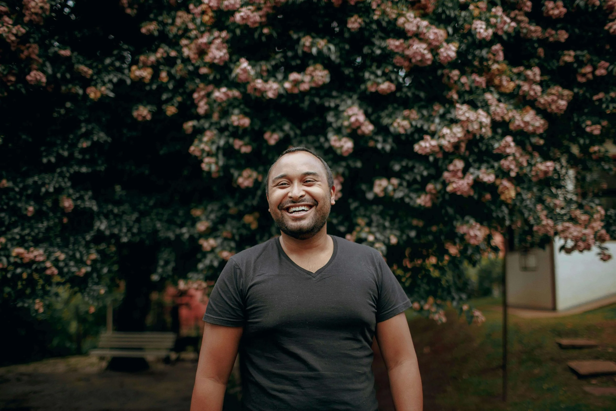 Person smiling joyfully outdoors, representing the freedom and authenticity possible after healing from adverse religious experiences in St. Paul, MN, and building relationship repair skills.