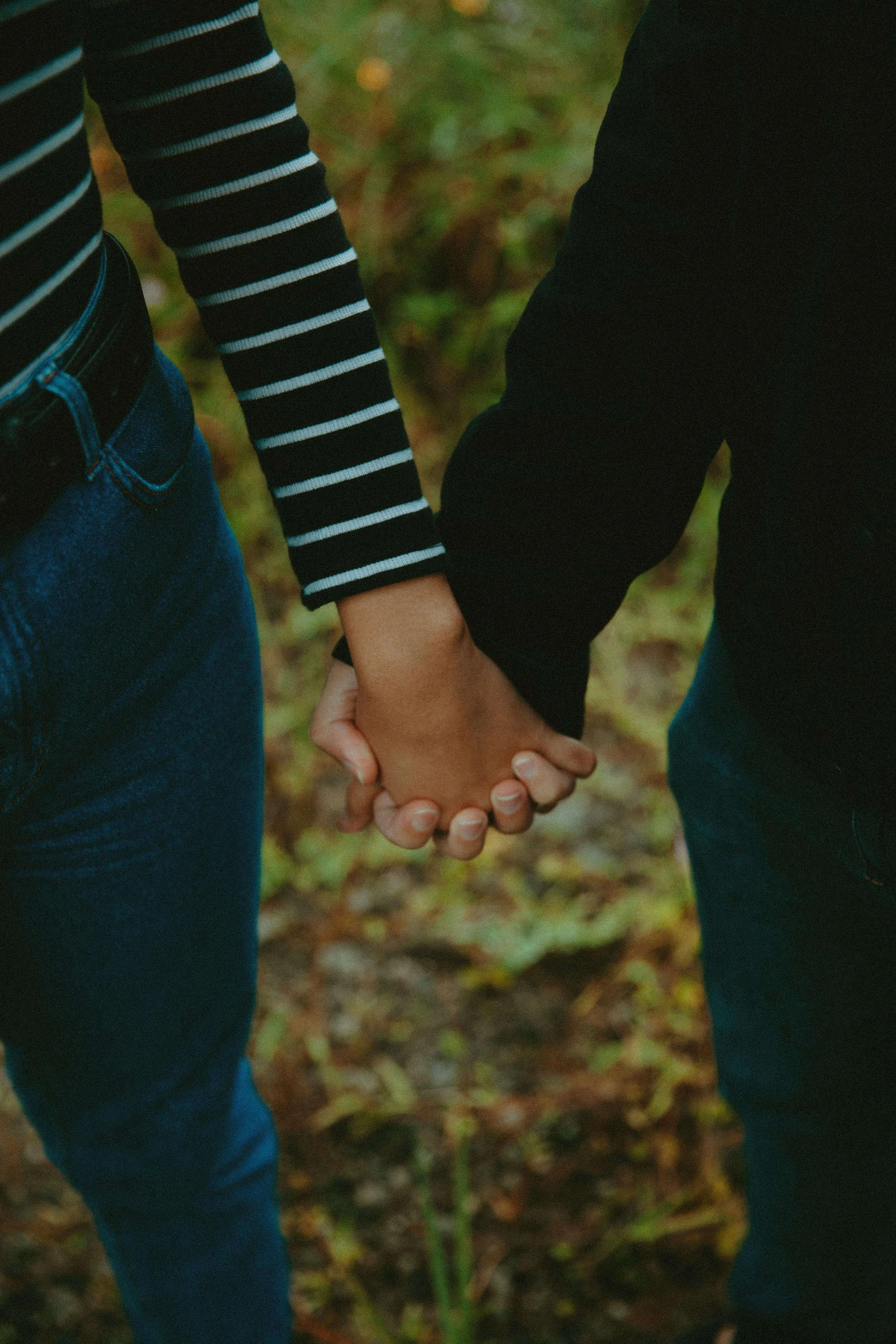 Two people hold hands while standing outdoors, capturing the slow rebuilding of physical closeness supported through religious trauma therapy in St. Paul and the affirming, identity-sensitive care of a gender identity therapist in St. Paul, MN.