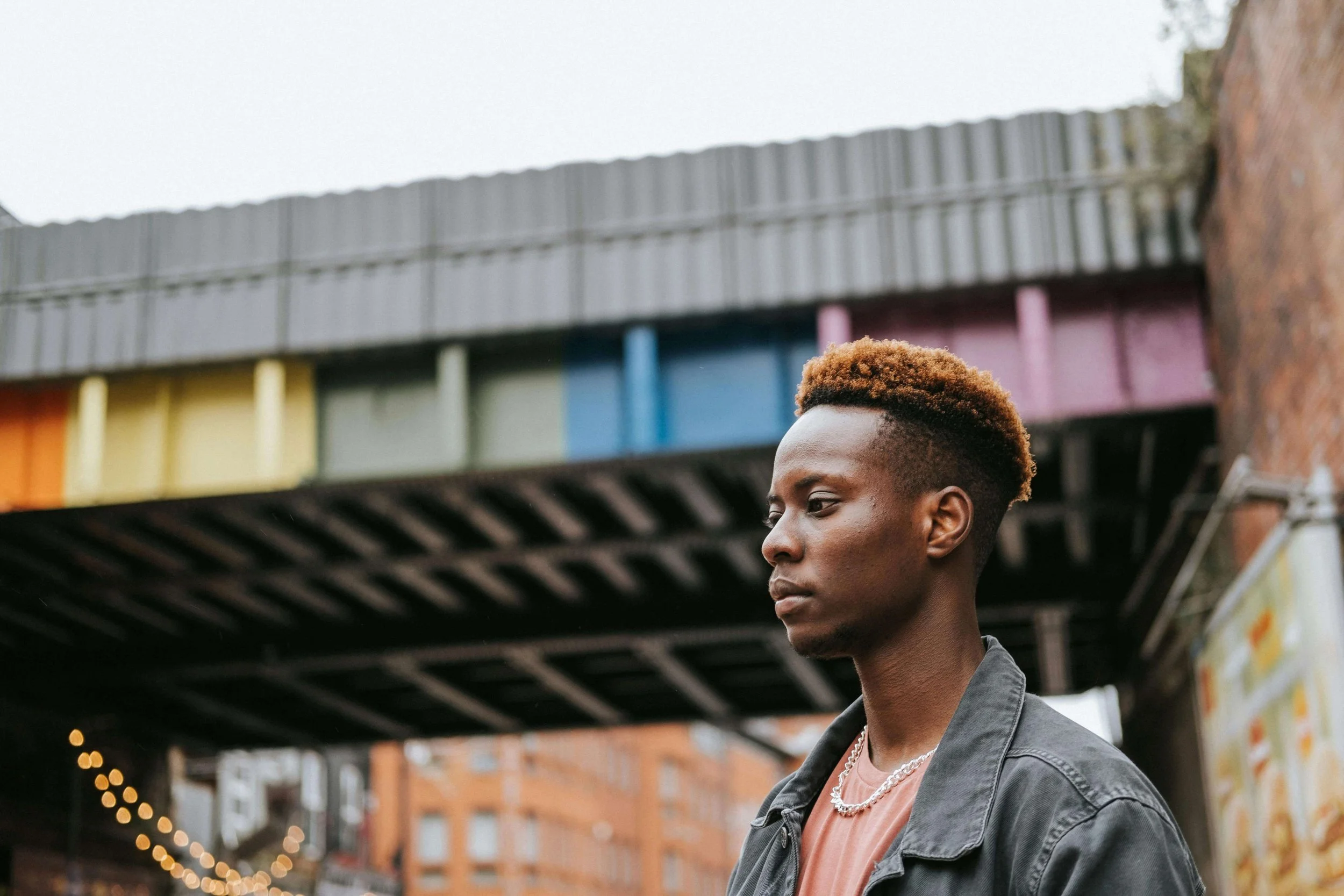 Person standing in urban setting looking contemplative, representing the journey of rebuilding self-trust through religious trauma therapy in St. Paul, MN, with a religious trauma therapist in St. Paul.