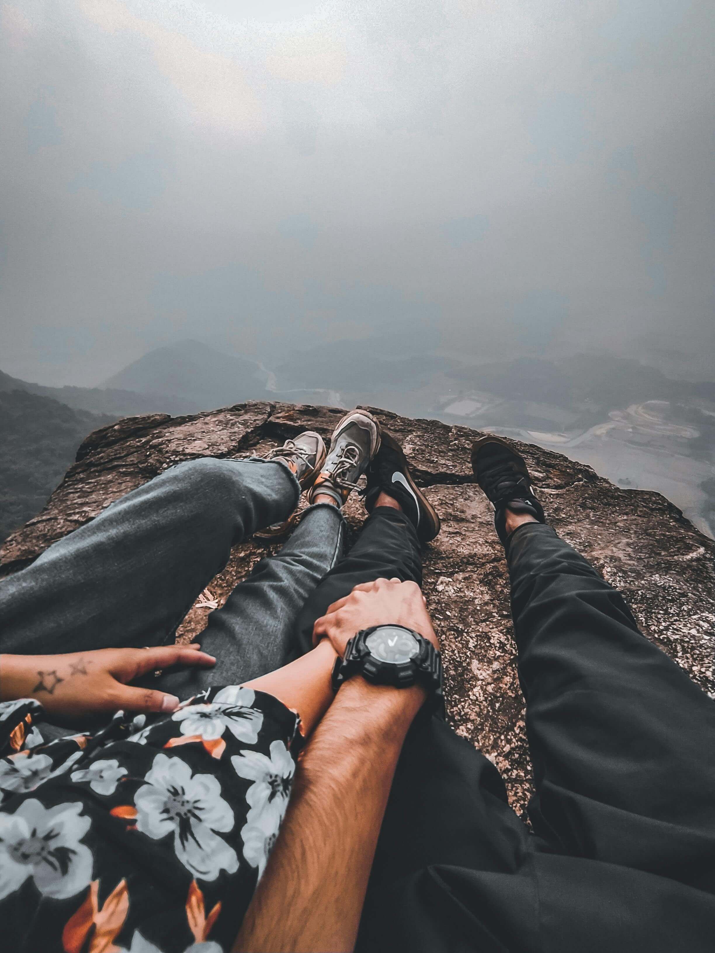 "Couple holding hands on mountain overlook while navigating ambivalence through virtual therapy for religious trauma in St. Paul, MN and somatic couples therapy in St. Paul, MN
