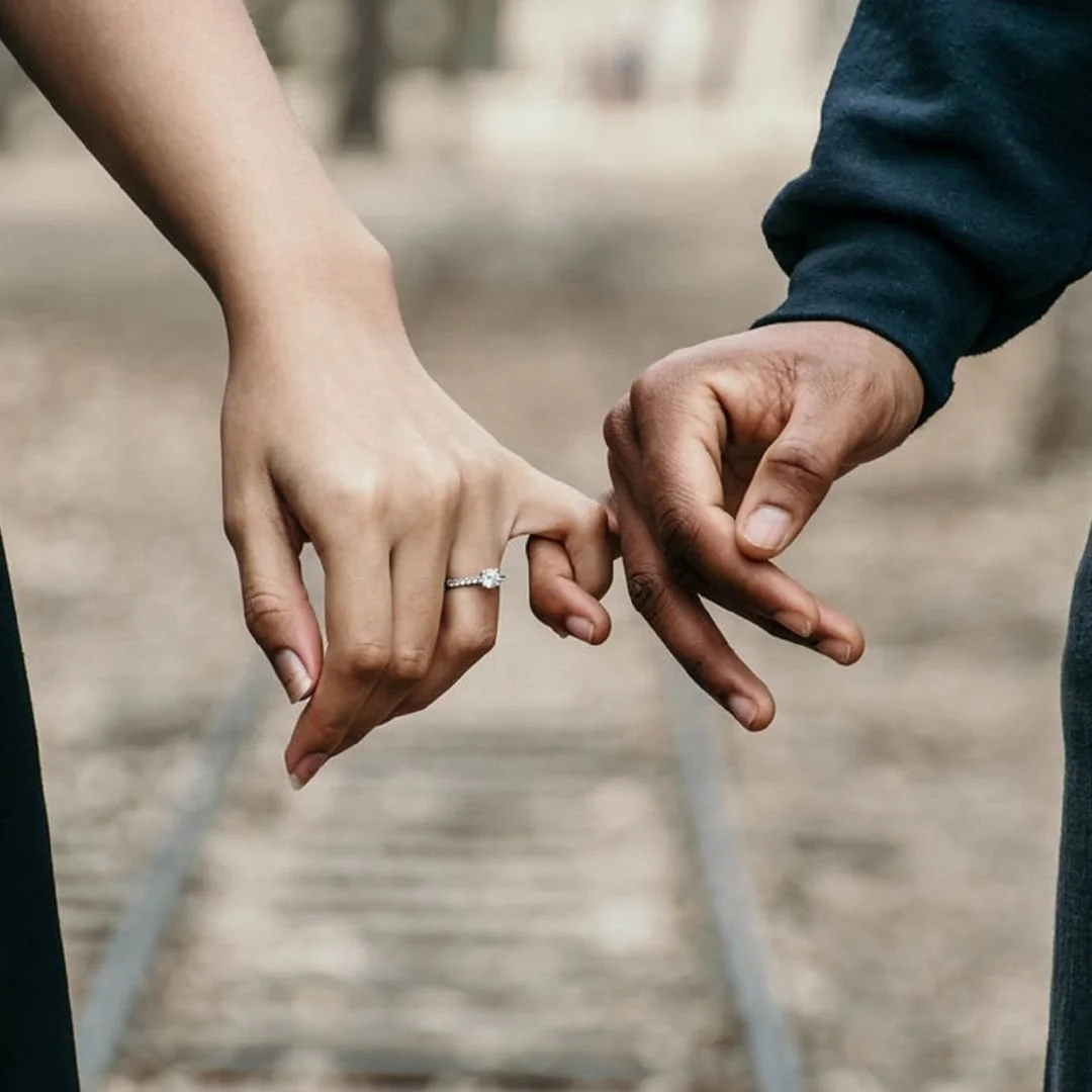 Two hands holding pinkies. This represents how Marcus Hunt Therapy has an anxiety therapist in Logan, Utah providing anxiety therapy for symptoms of anxiety through online therapy in Utah.