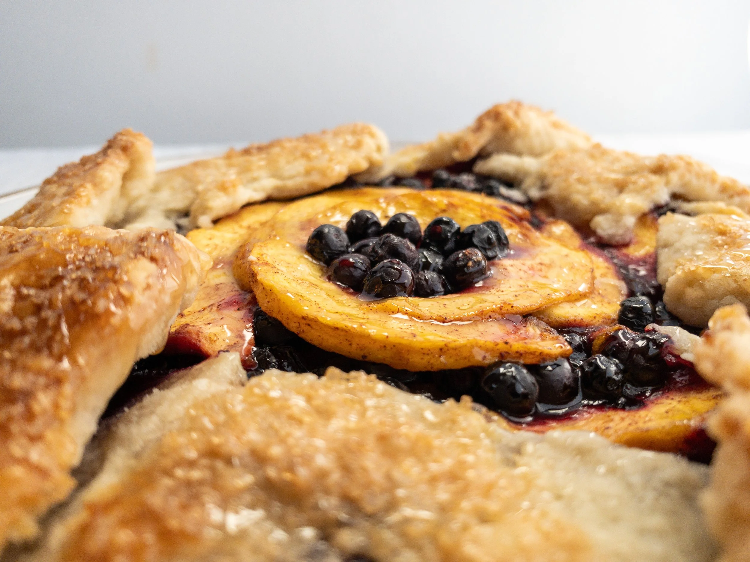 Alpine foraged wild blueberry and huckleberry with peach galette