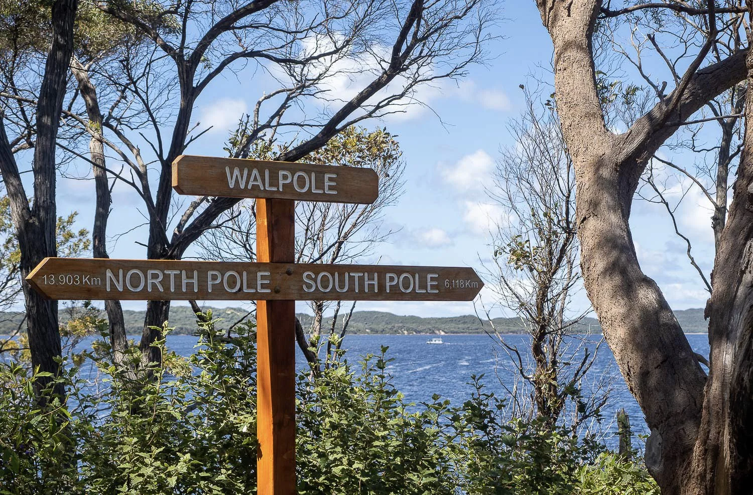 Walpole location sign pointing to north and south poles