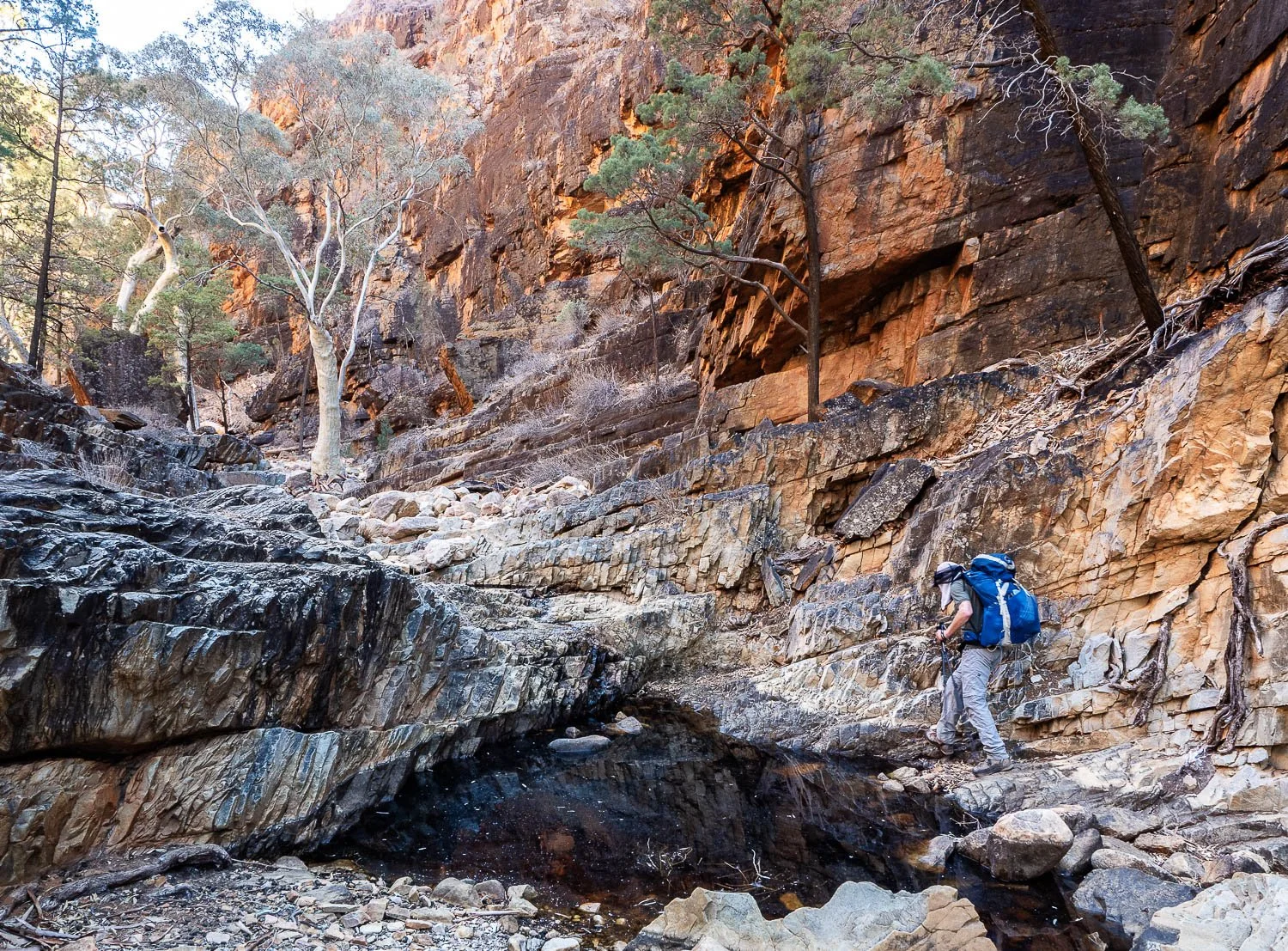 hiker in step sided rock gorge