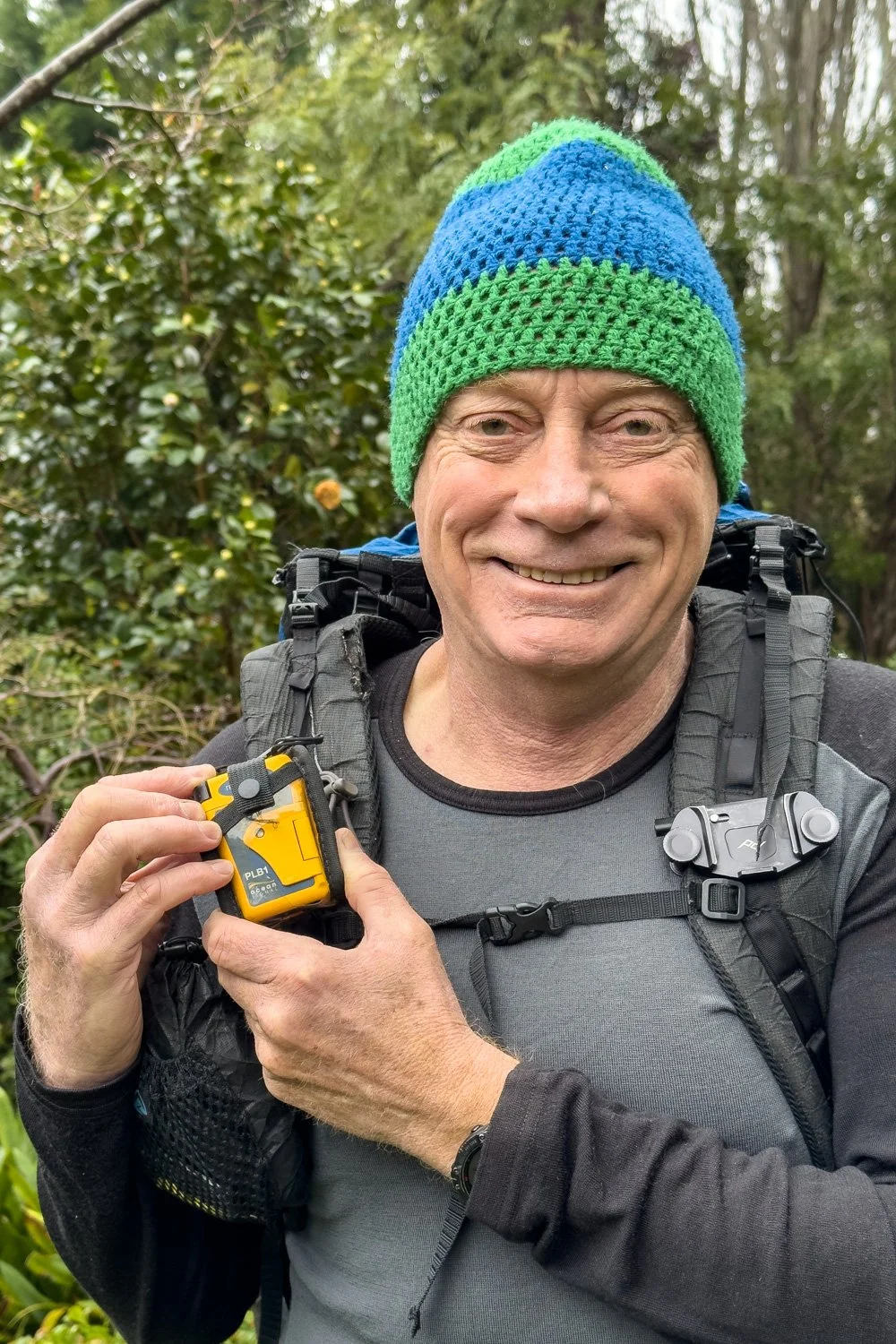 hiker illustrating accessibility of PLB by either hand
