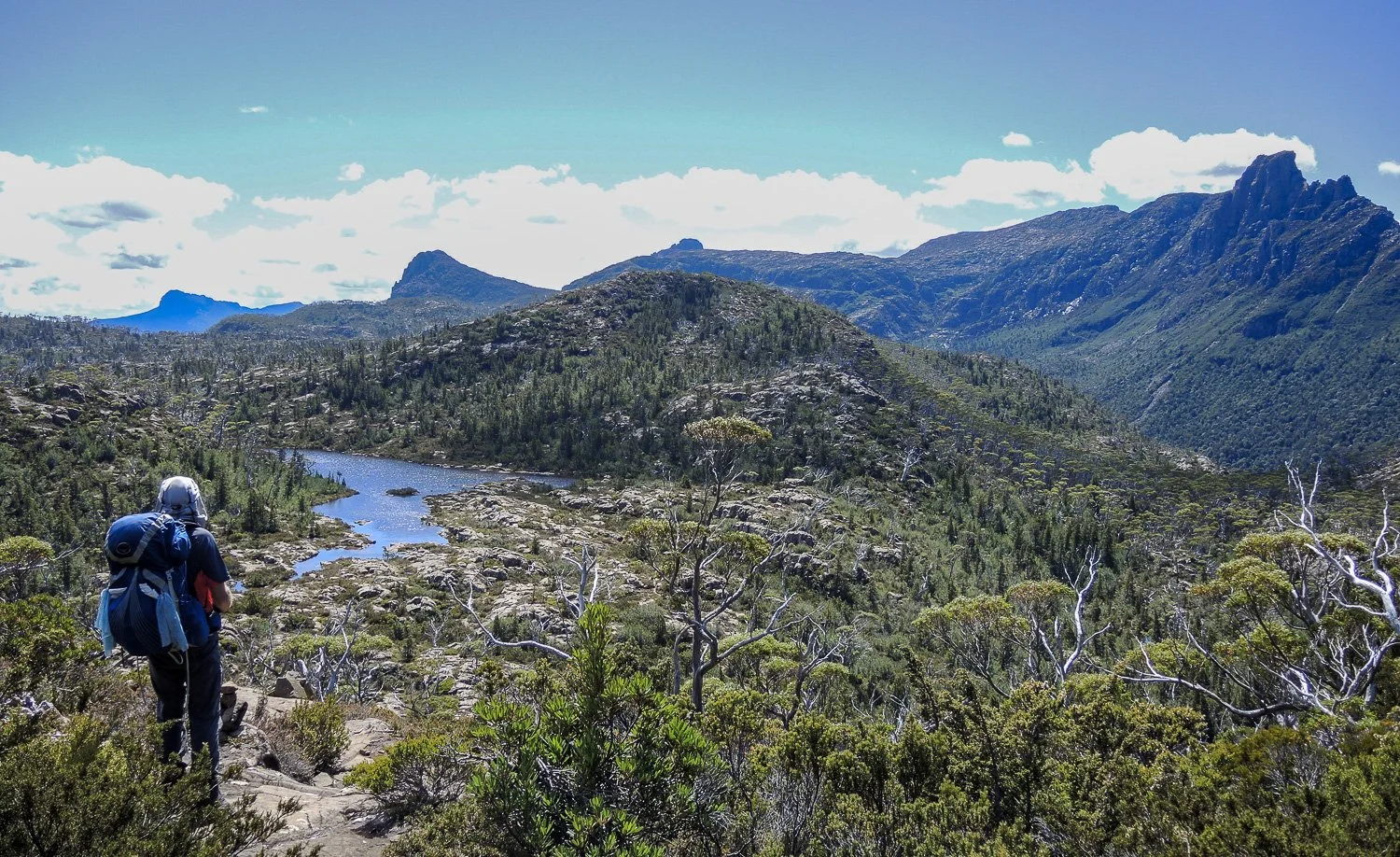 hiker on rocky outcrop with no visible track ahead
