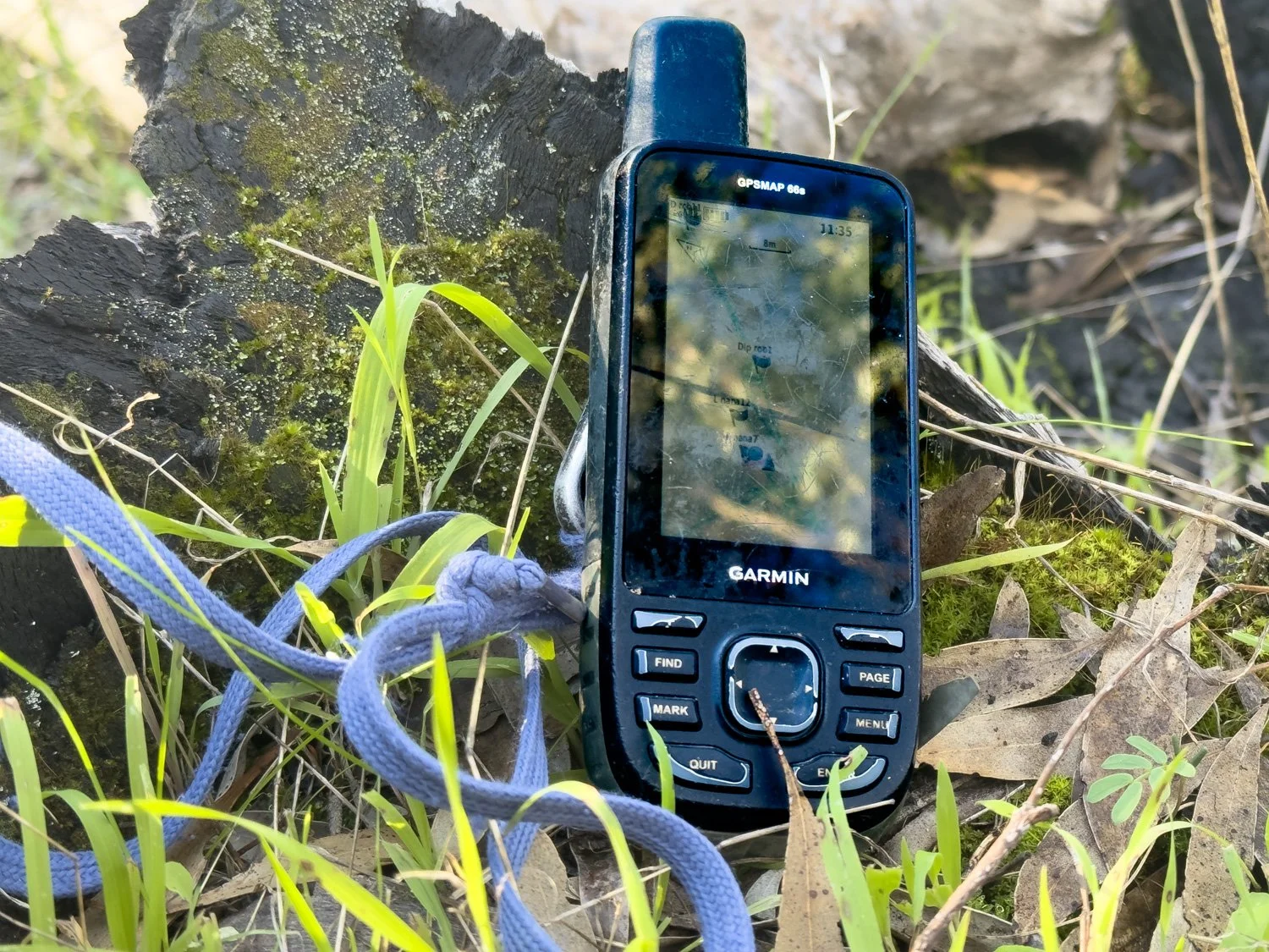 picture of Garmin’s 66sMap on ground in forest