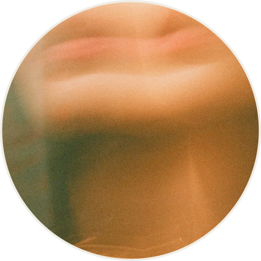 blurry image of a face with only the lips, neck, and chin showing