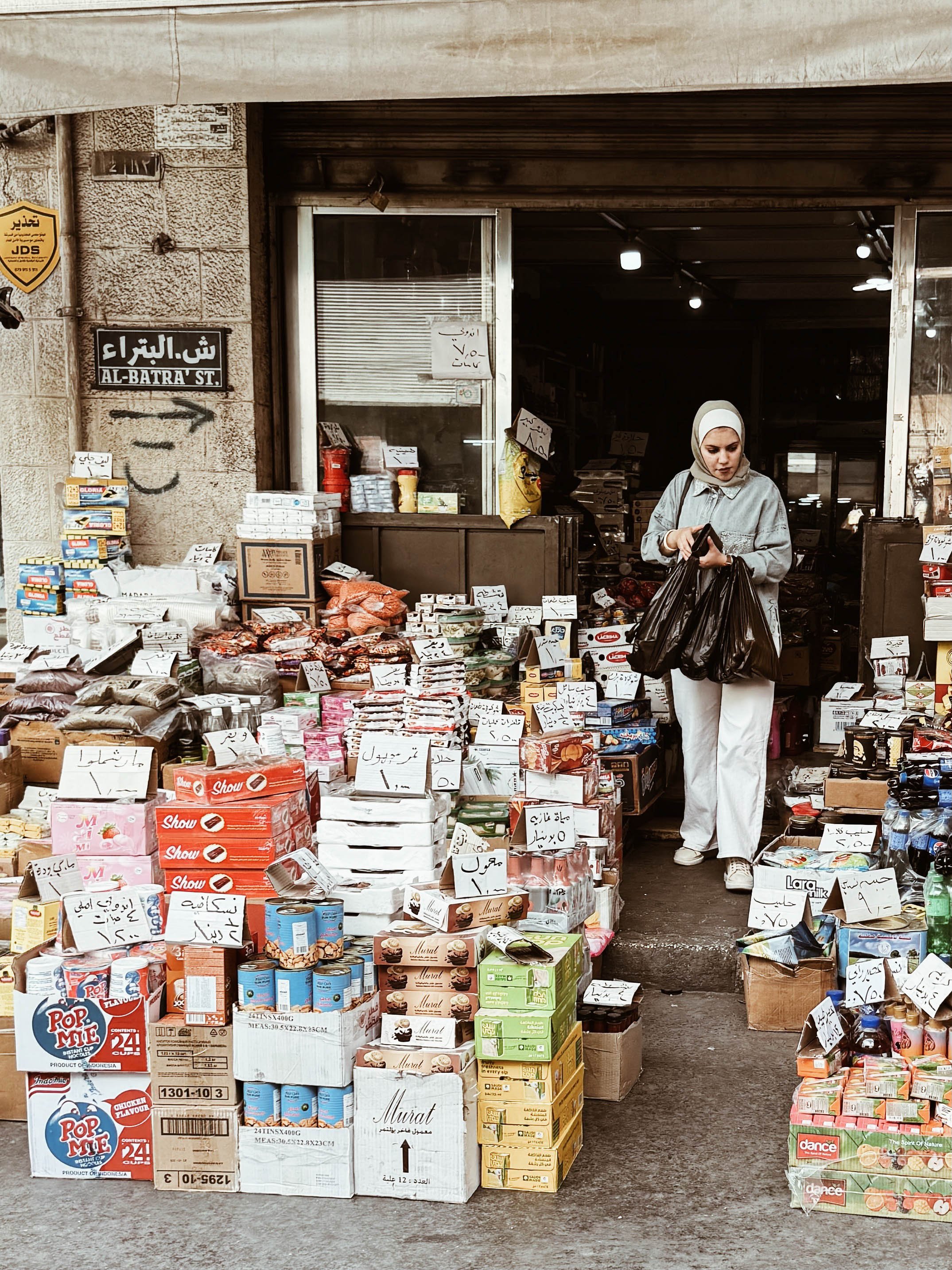 local-woman-comin-out-local-shop-amman-jordan.jpg