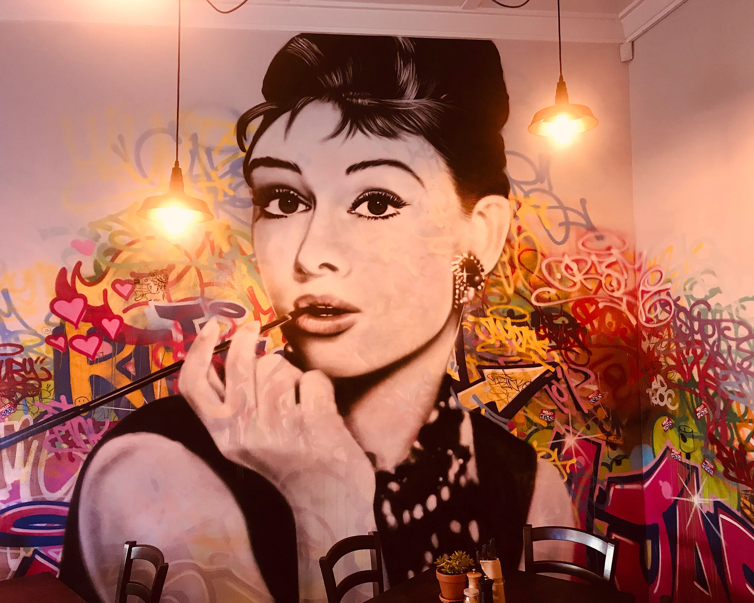 This Audrey Hepburn portrait with layered graffiti style background mural was created for Harbour kitchen located in the Suburb of Remuera in the city of Auckland.