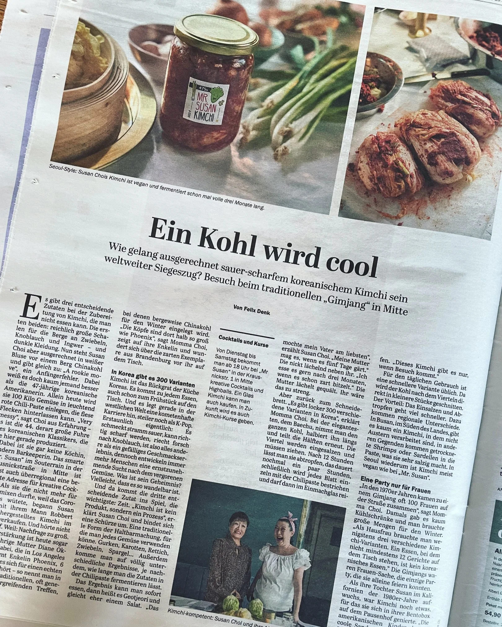 A newspaper article featuring images of homemade kimchi, green onions, and kimchi-filled dumplings on a cutting board.