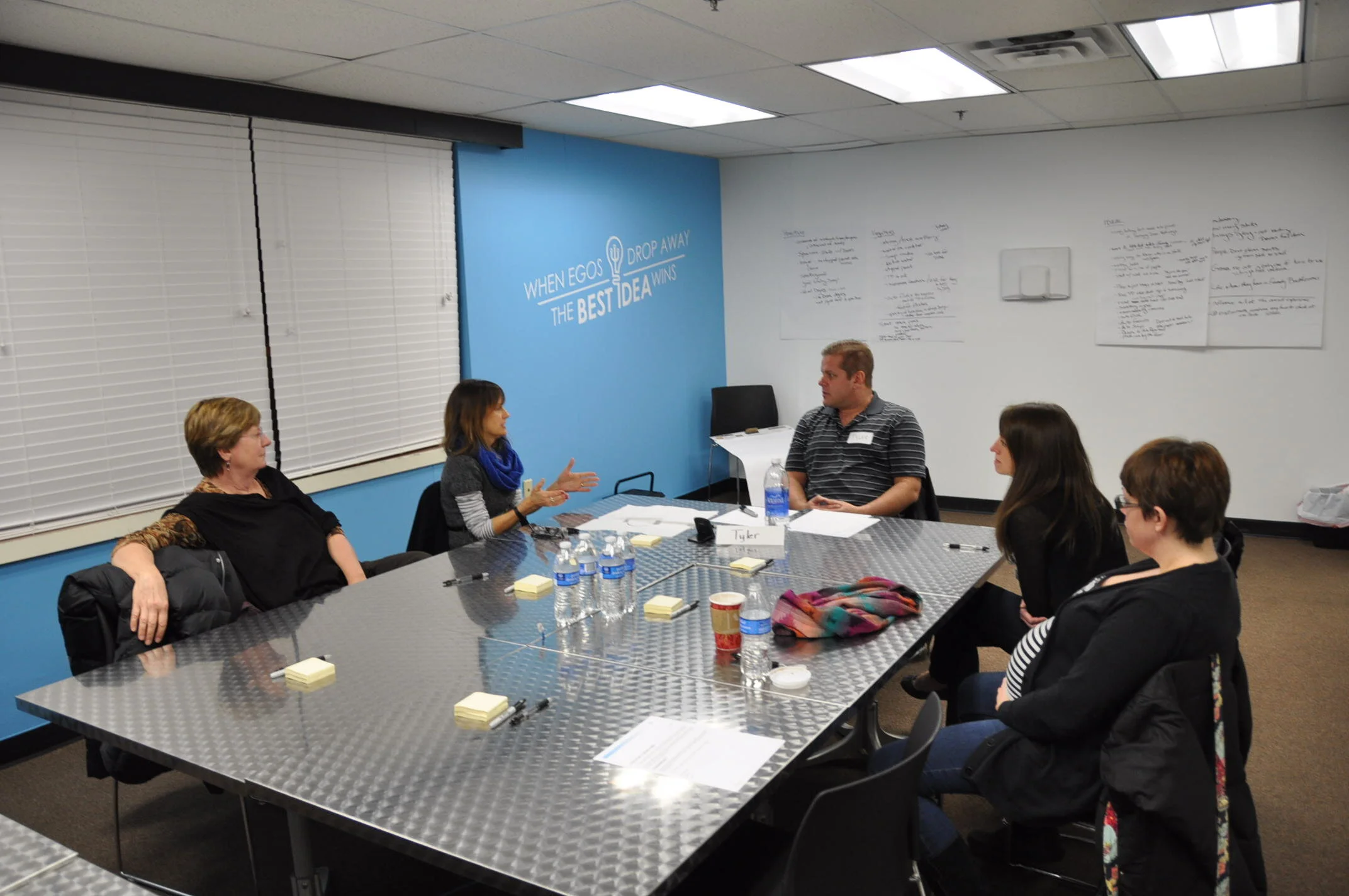 Female focus group participants discuss their experiences with the facilitator.