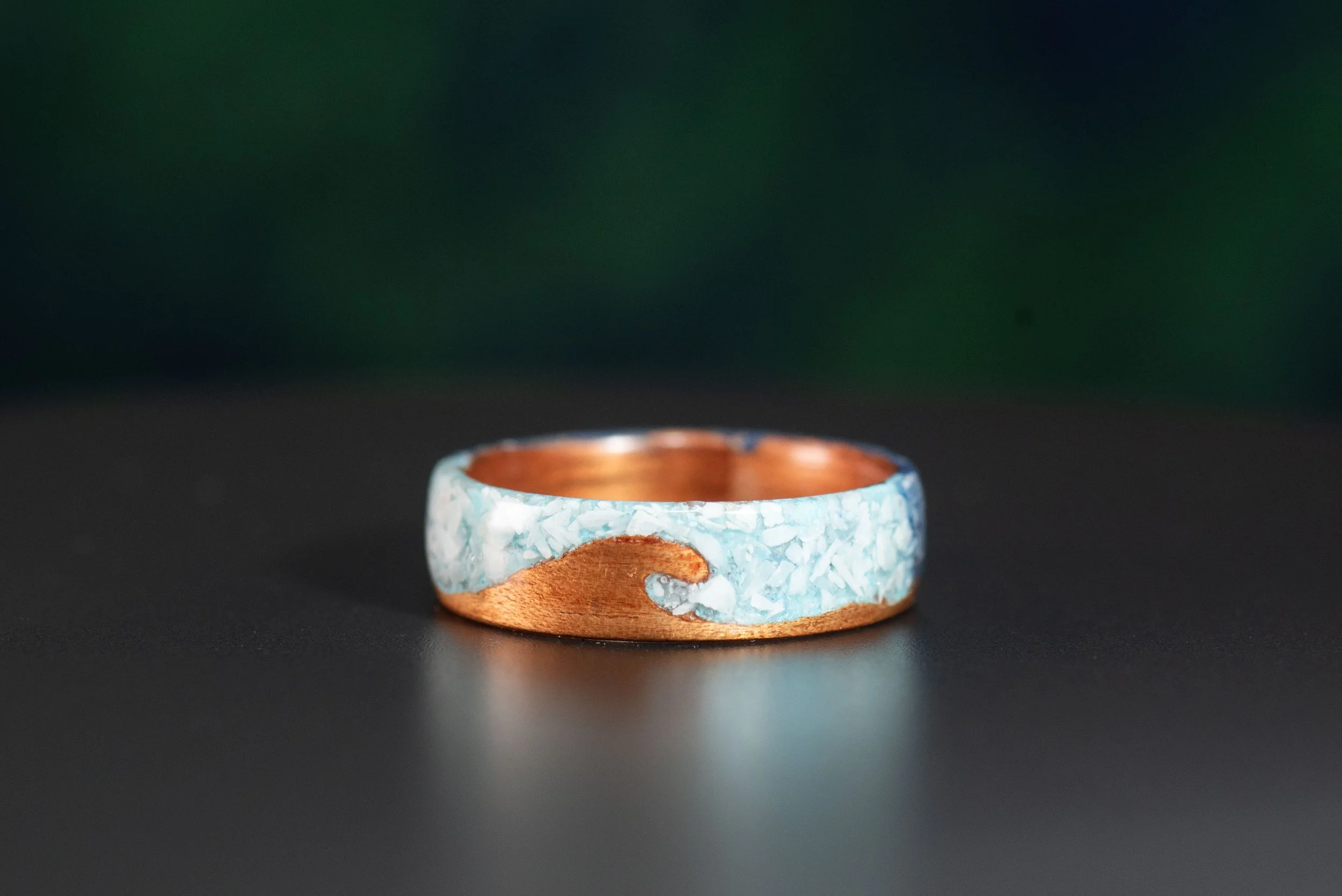 Koa wood ocean ring with turquoise and larimar gemstone inlay and customizable ring core.