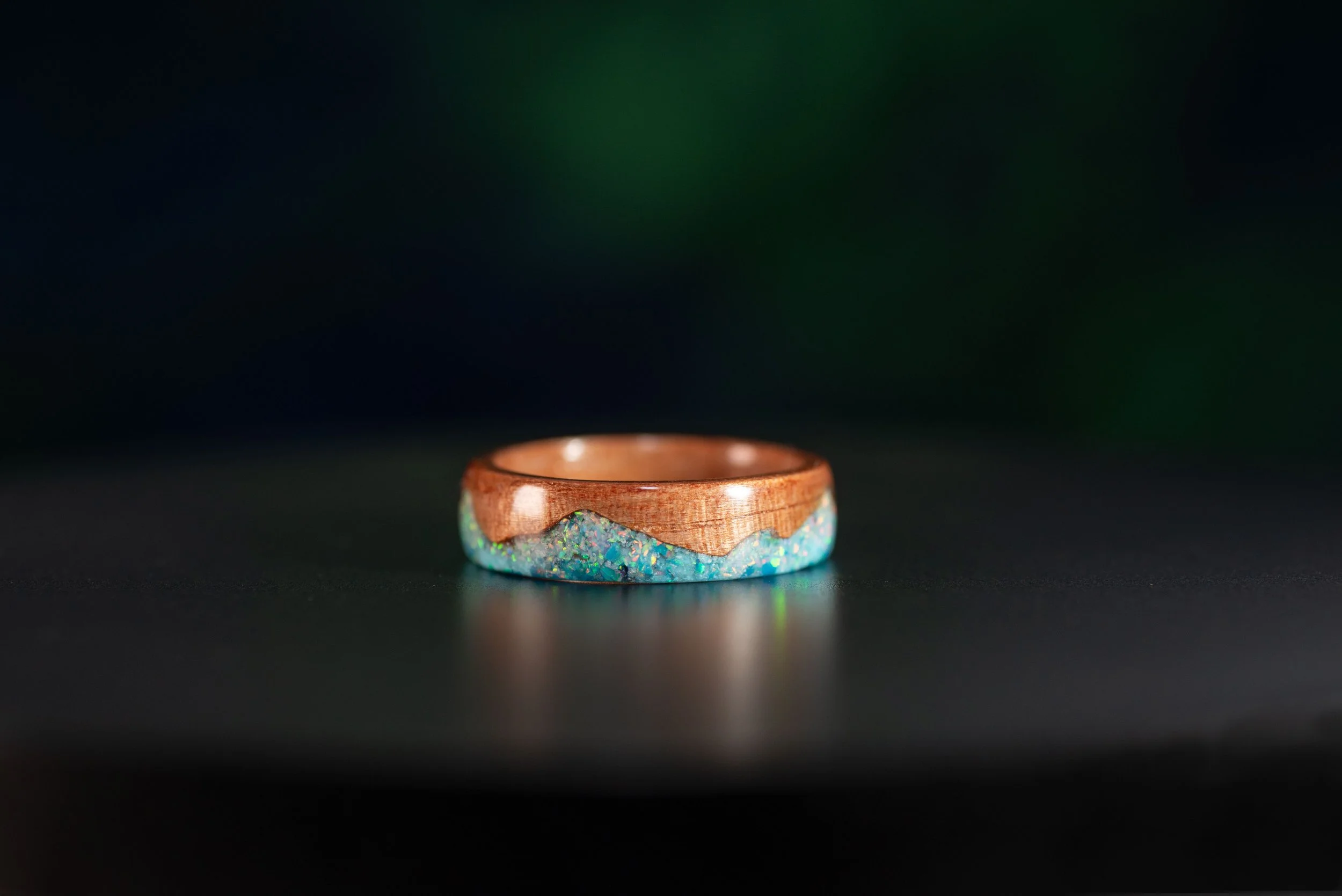 Custom tineo wood ring with blue and turquoise stone inlay and white opal peaks