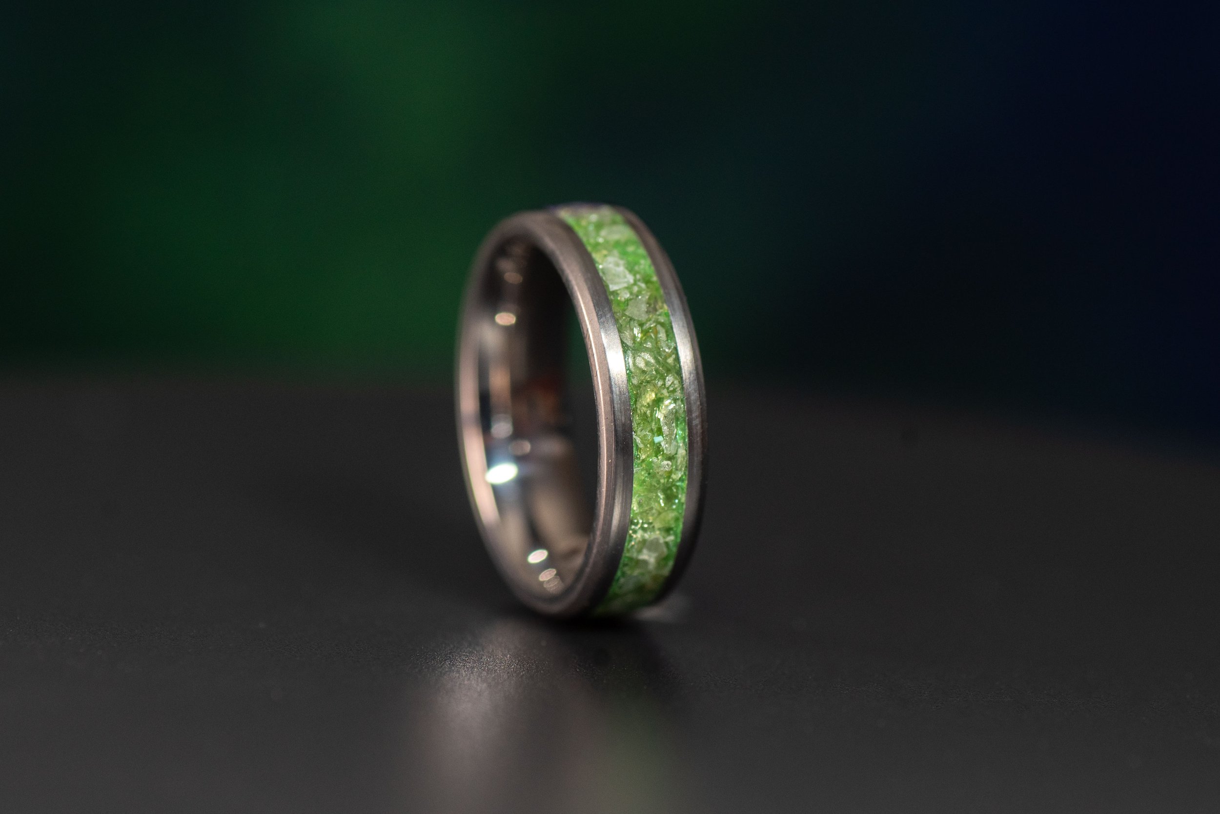Unique peridot titanium ring, a durable and elegant birthstone wedding or engagement band.