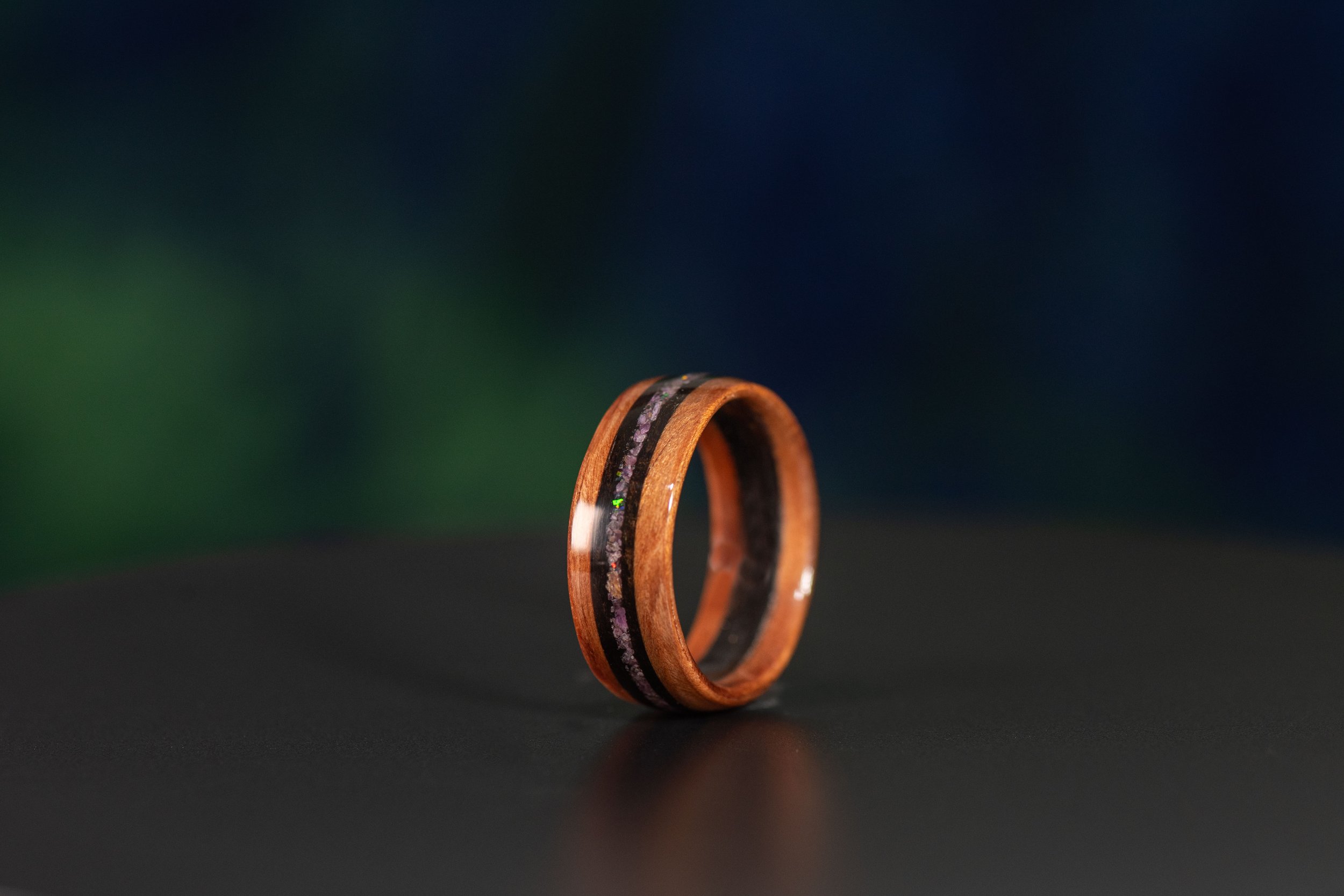 Handcrafted redwood and smoked rosewood ring with garnet and black opal