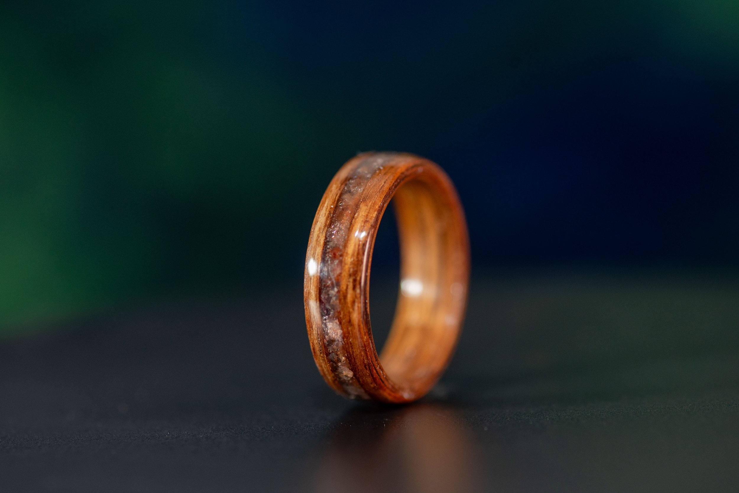 Nature inspired wood wedding band with warm sunstone accents