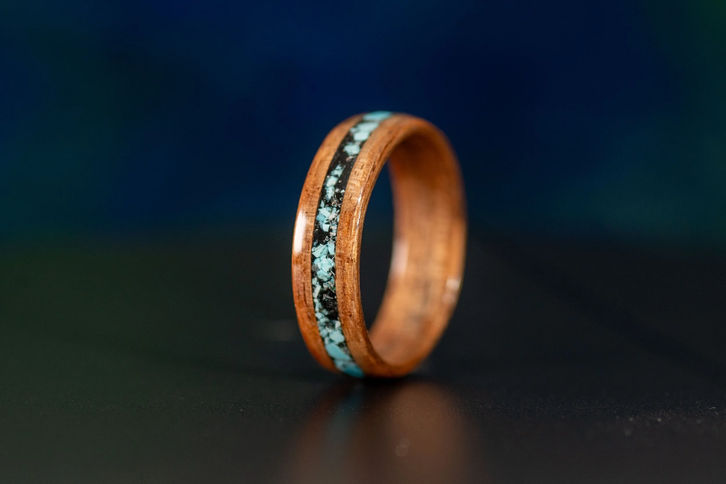 Nature inspired wood ring featuring vibrant turquoise and dark black tourmaline