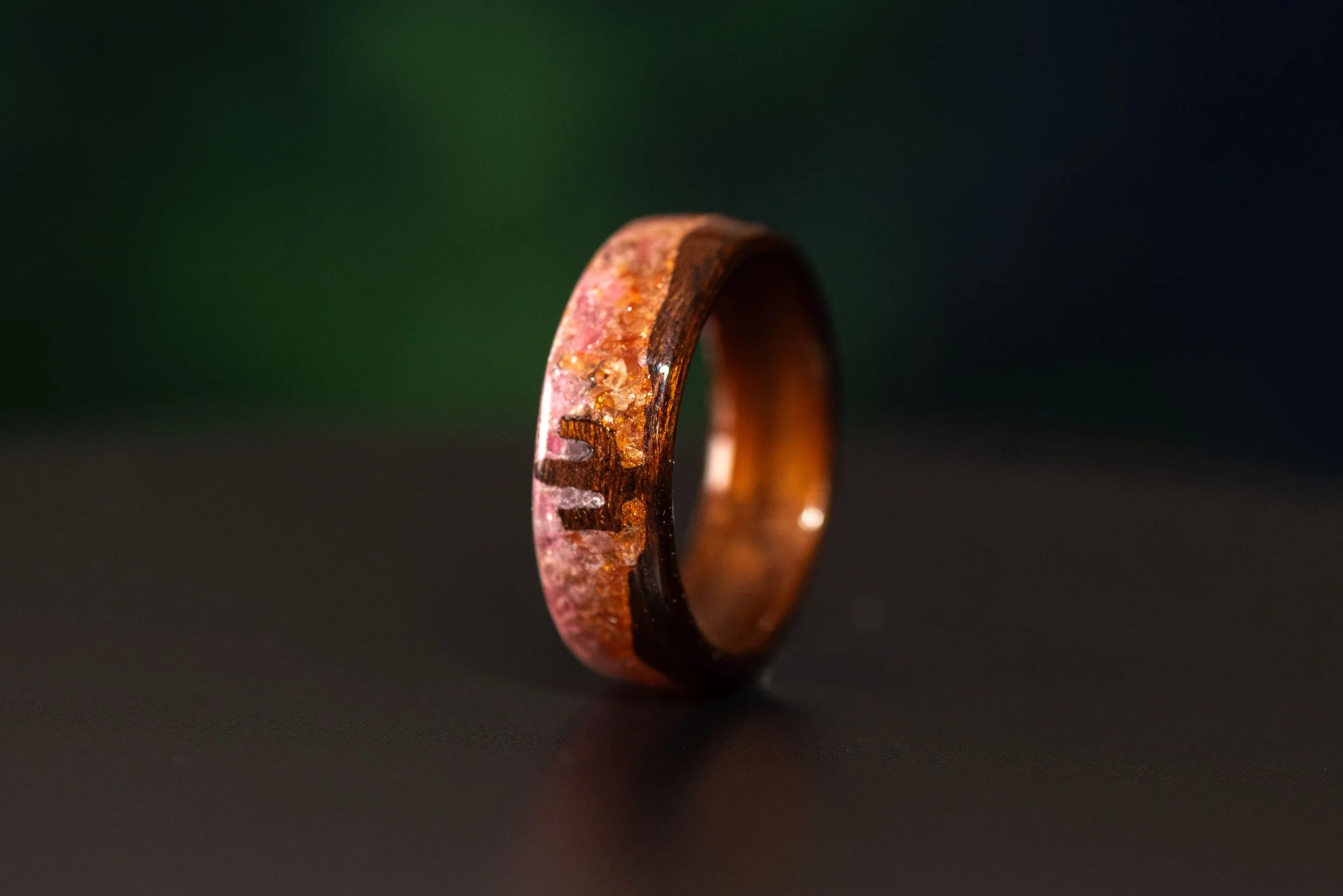 Southwest inspired wood ring featuring a saguaro cactus and pink orange gemstone sunset design.
