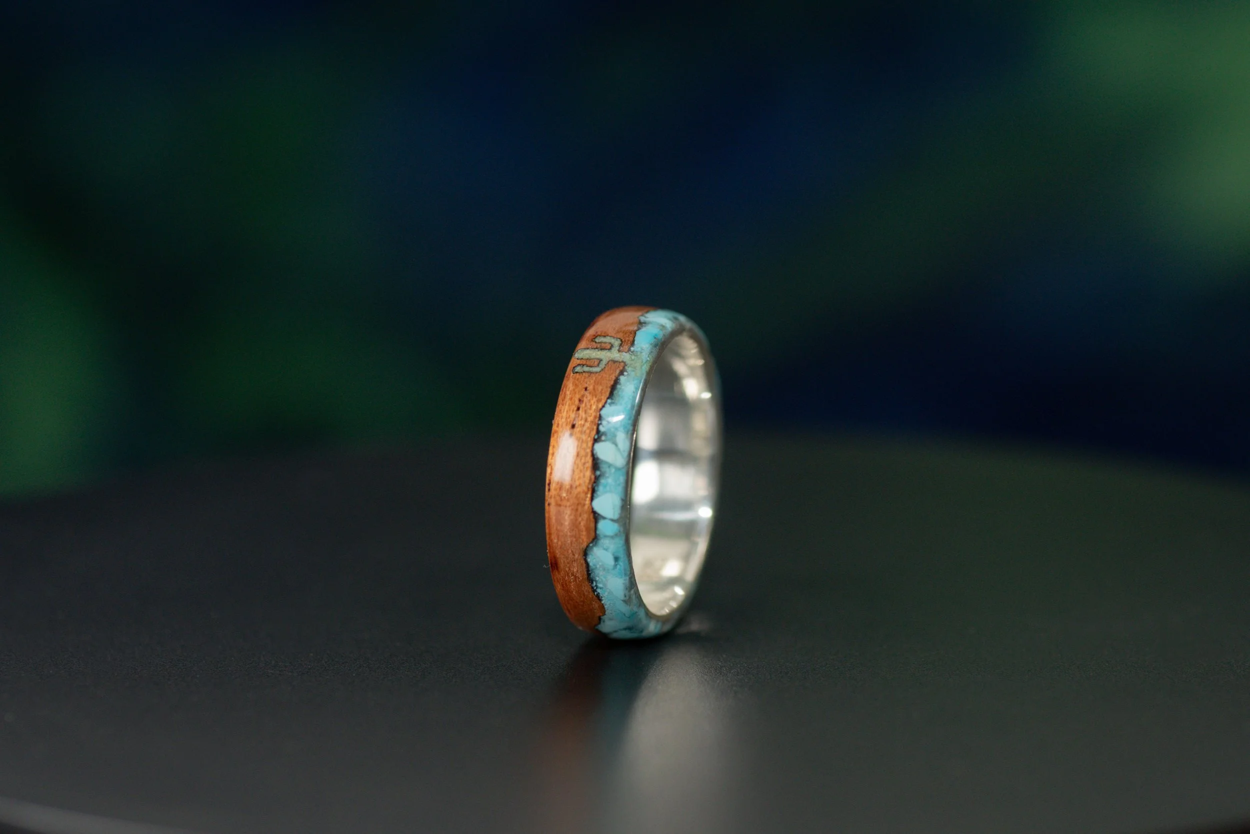 Nature inspired desert ring with cactus and mountain design made from turquoise in cedar wood.