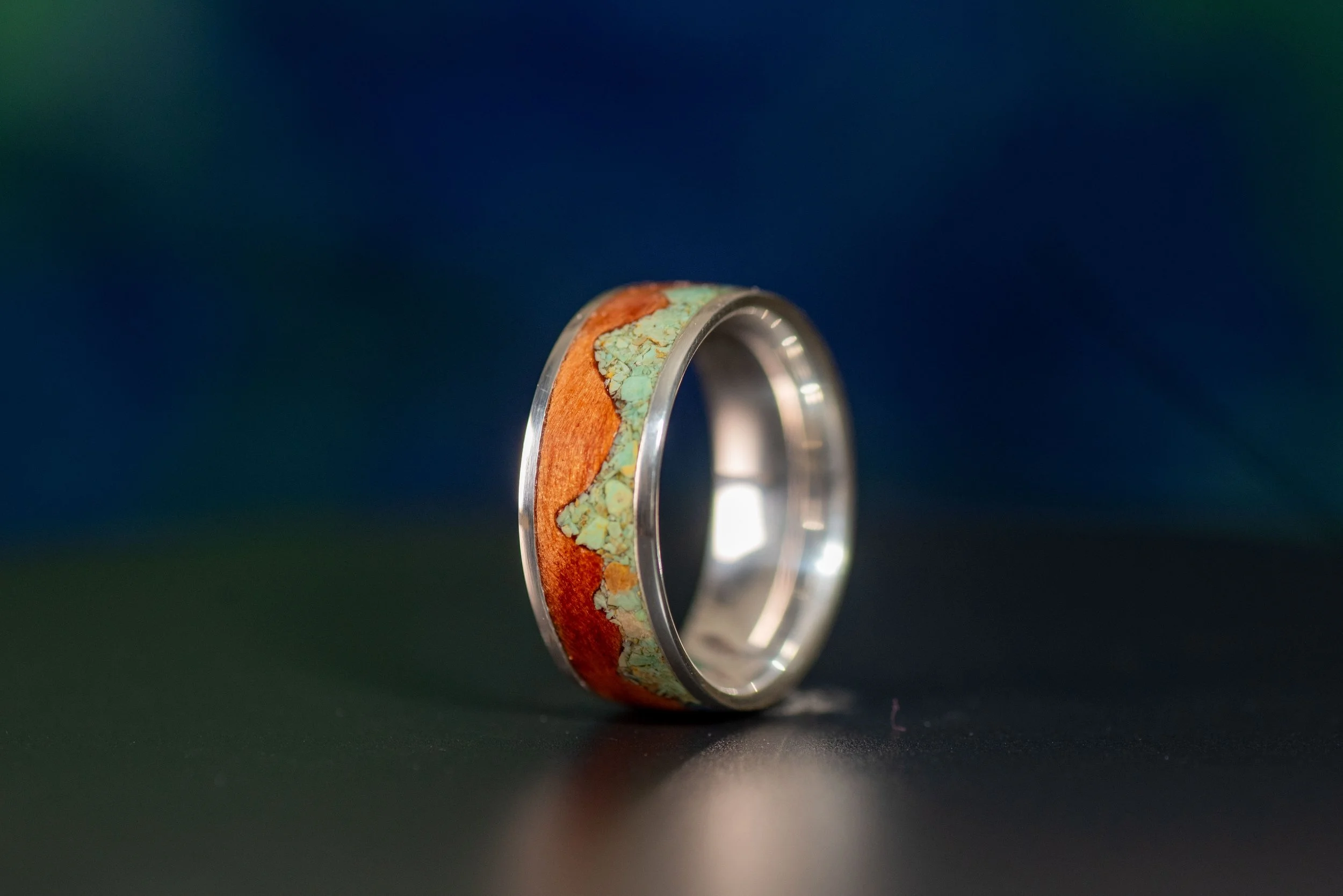 Handcrafted sterling silver and redwood ring featuring a green Sonoran turquoise mountain design.