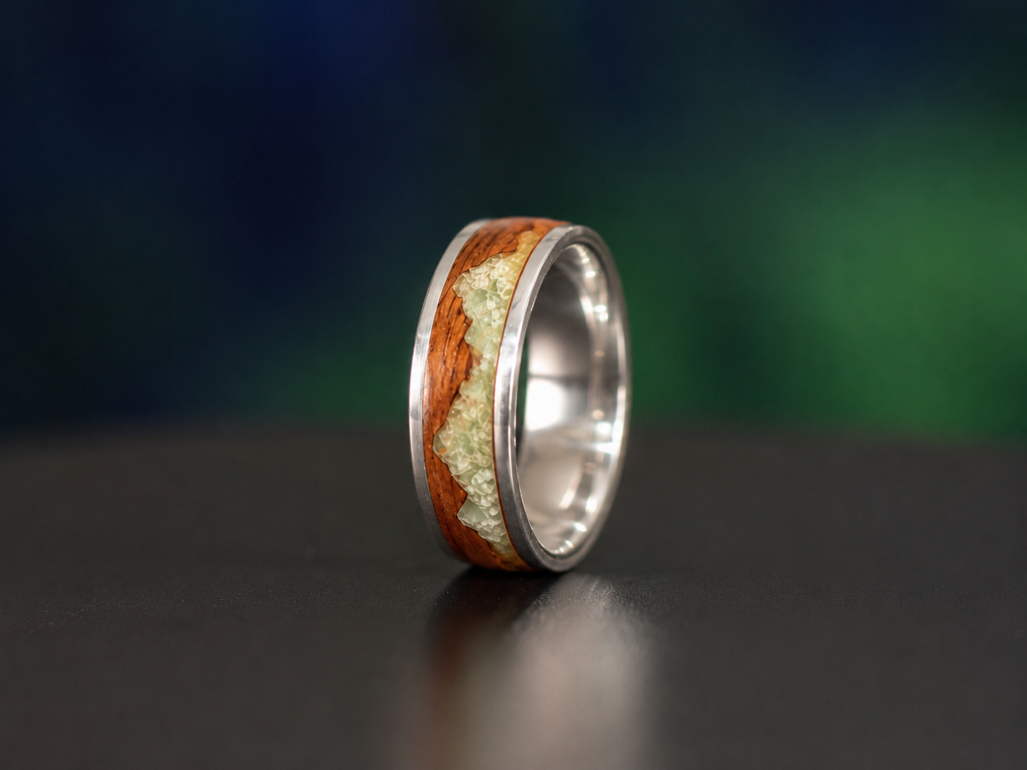 side view of sterling silver ring with jade mountain inlay