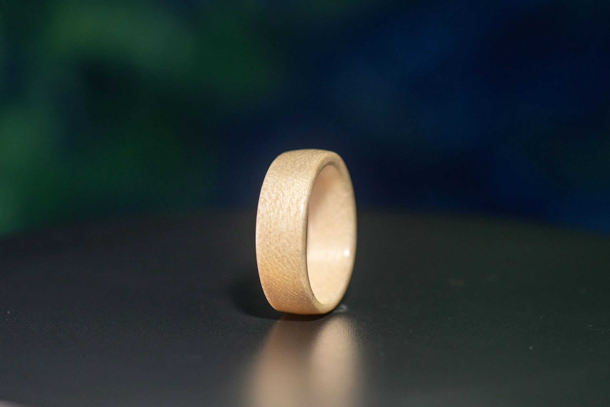 Nature inspired wood ring featuring warm maple grain