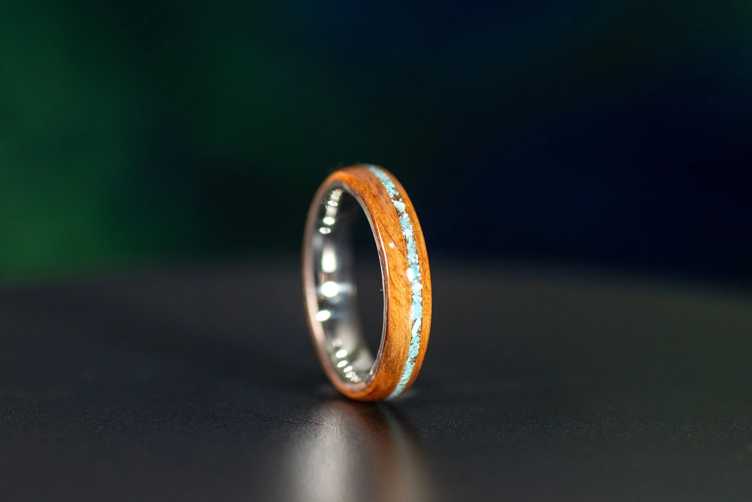 Handcrafted redwood wood ring showcasing delicate turquoise inlay