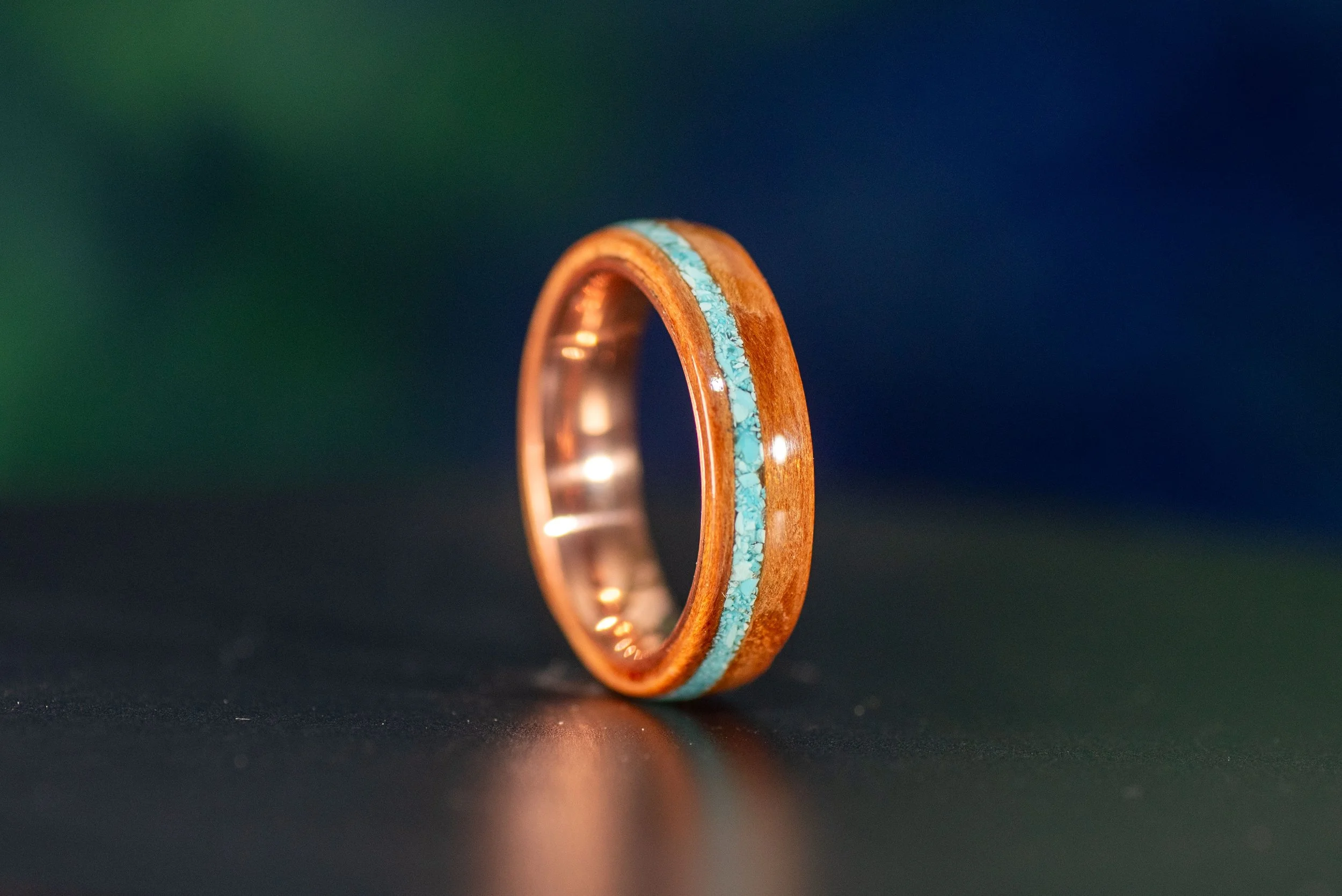 Nature inspired wood ring featuring subtle turquoise accent copper ring core