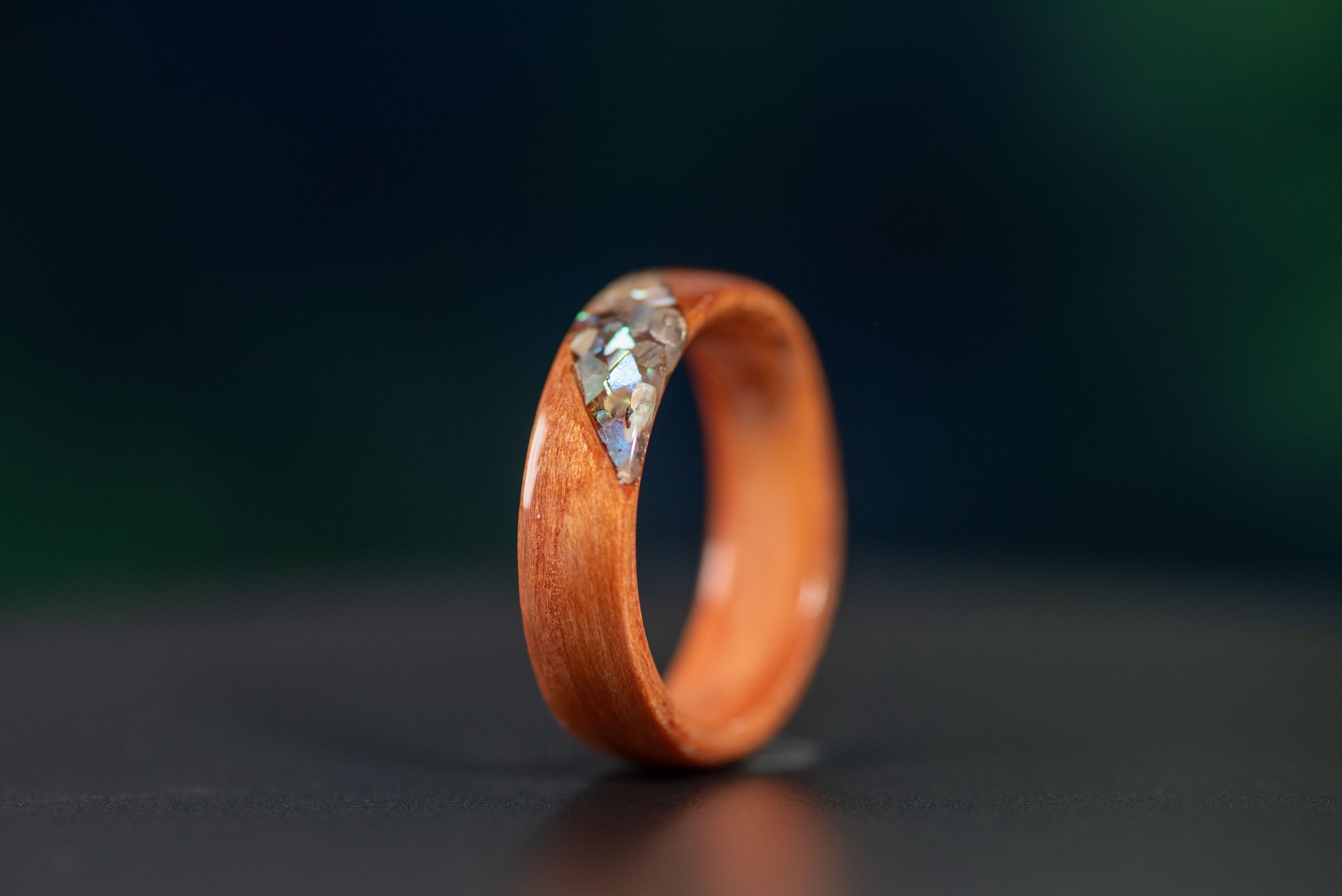 Men’s redwood wood ring with colorful abalone inlay inspired by the California coast.