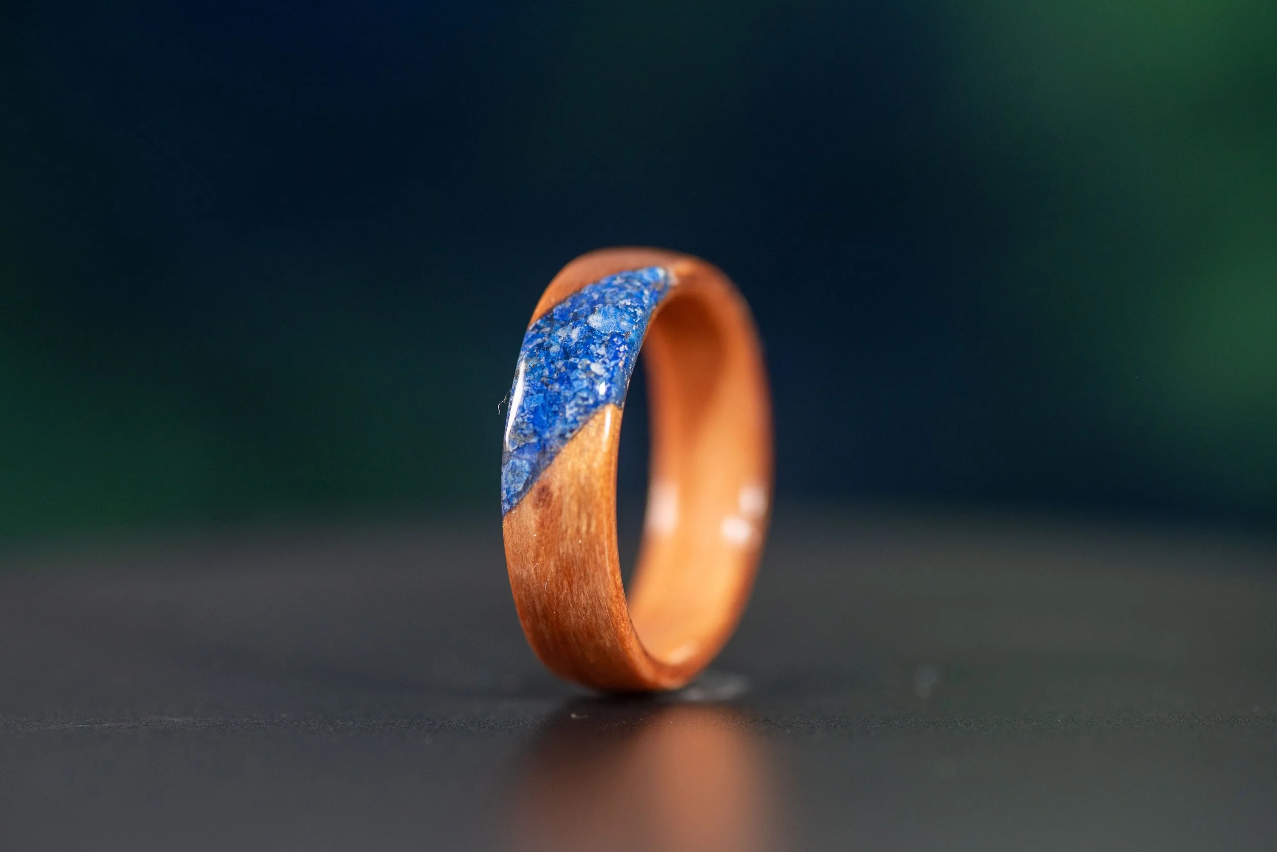 Nature inspired wood ring featuring deep blue lapis inlay