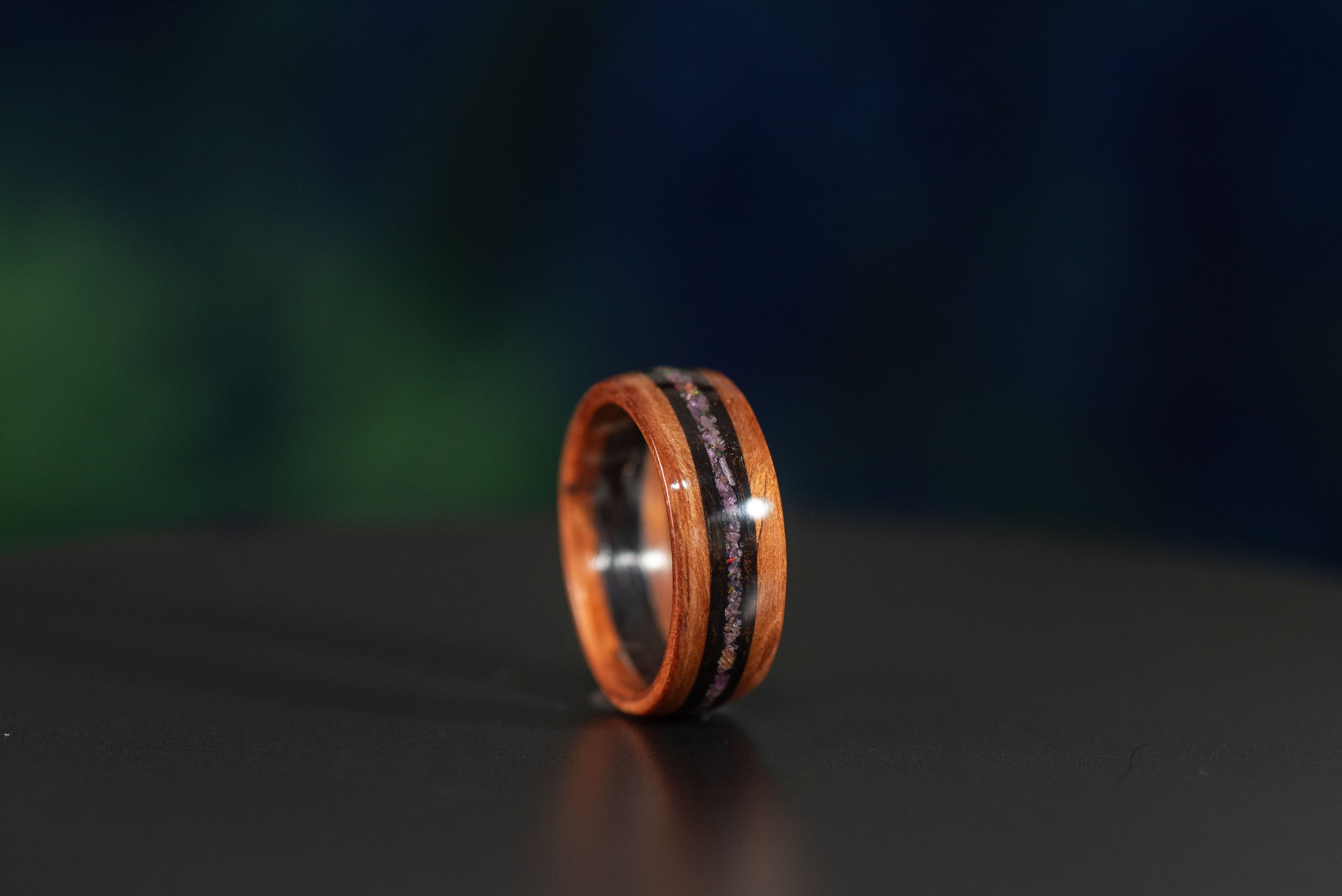 Nature inspired wood wedding band with opal and garnet inlay