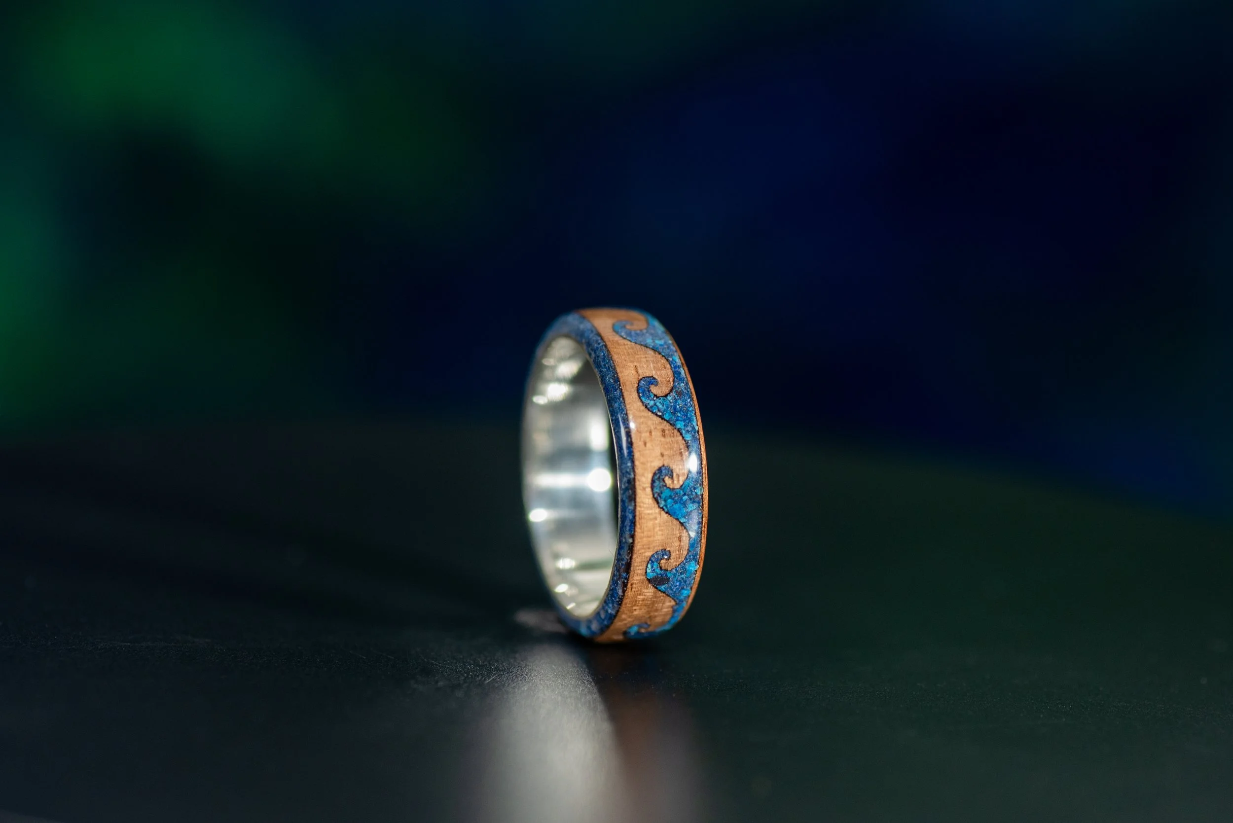 Travel inspired Santander wave ring with walnut wood and blue gemstone inlay.