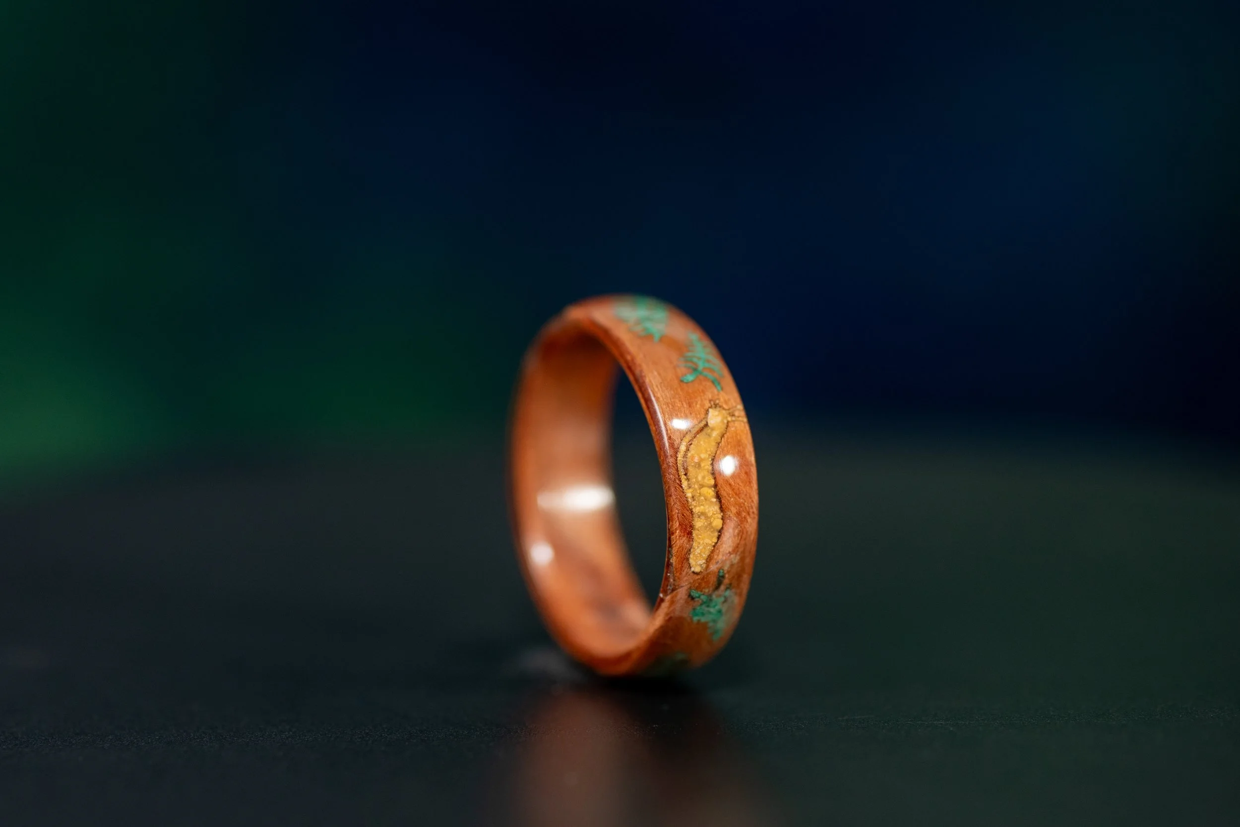 UCSC inspired banana slug ring handcrafted from redwood with yellow jasper and malachite gemstone inlay.